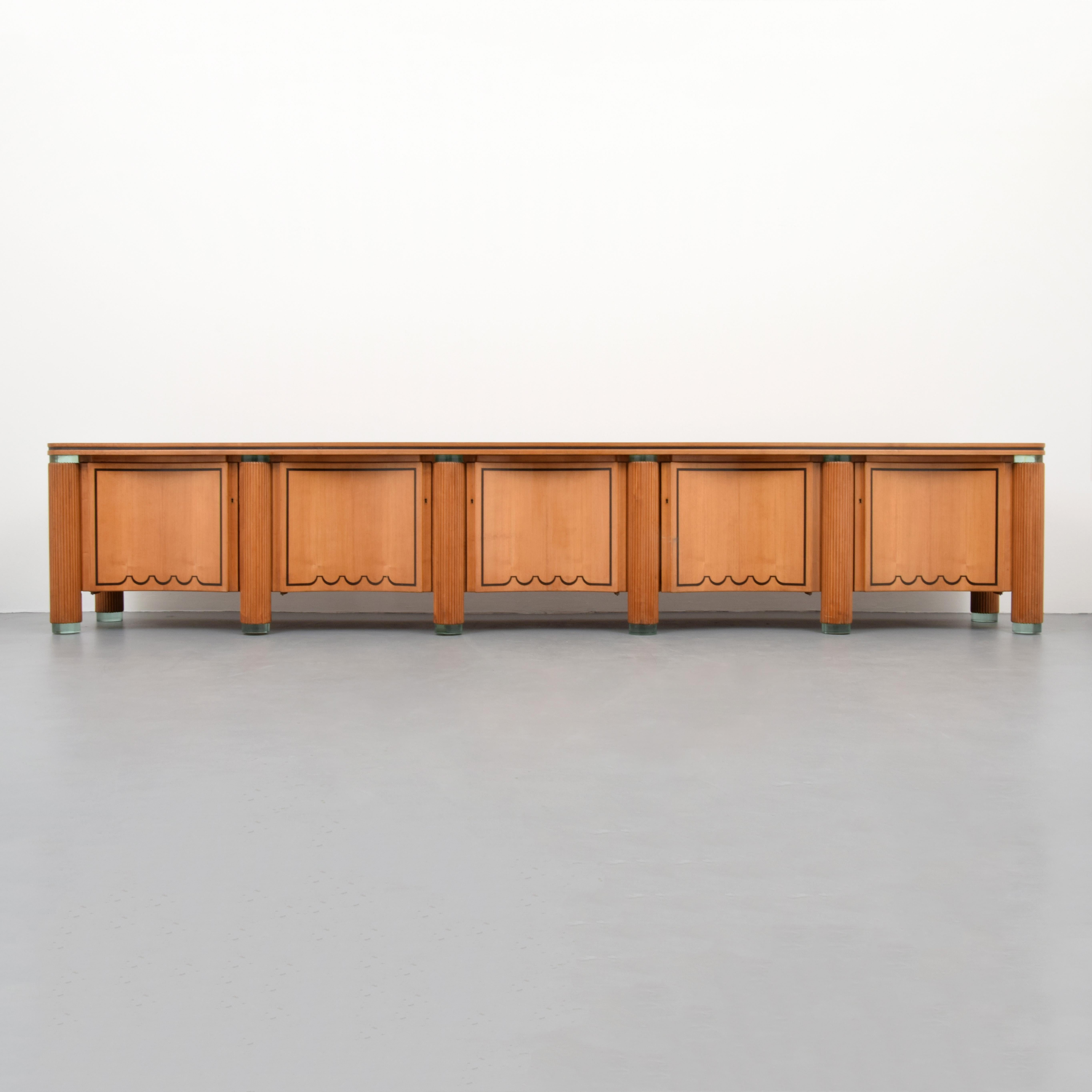 Monumental and important cabinet attributed to Giuseppe Terragni (Italian, 1904-1943) from the Novecento Italiano period. Six glass feet are spaced equally along the front of the cabinet with two glass feet in the rear. Each column is wrapped with