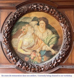 Monumental carved walnut fireplace with atlantes and painted medallion