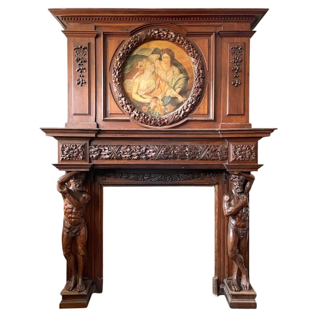 Monumental carved walnut fireplace with atlantes and painted medallion For Sale