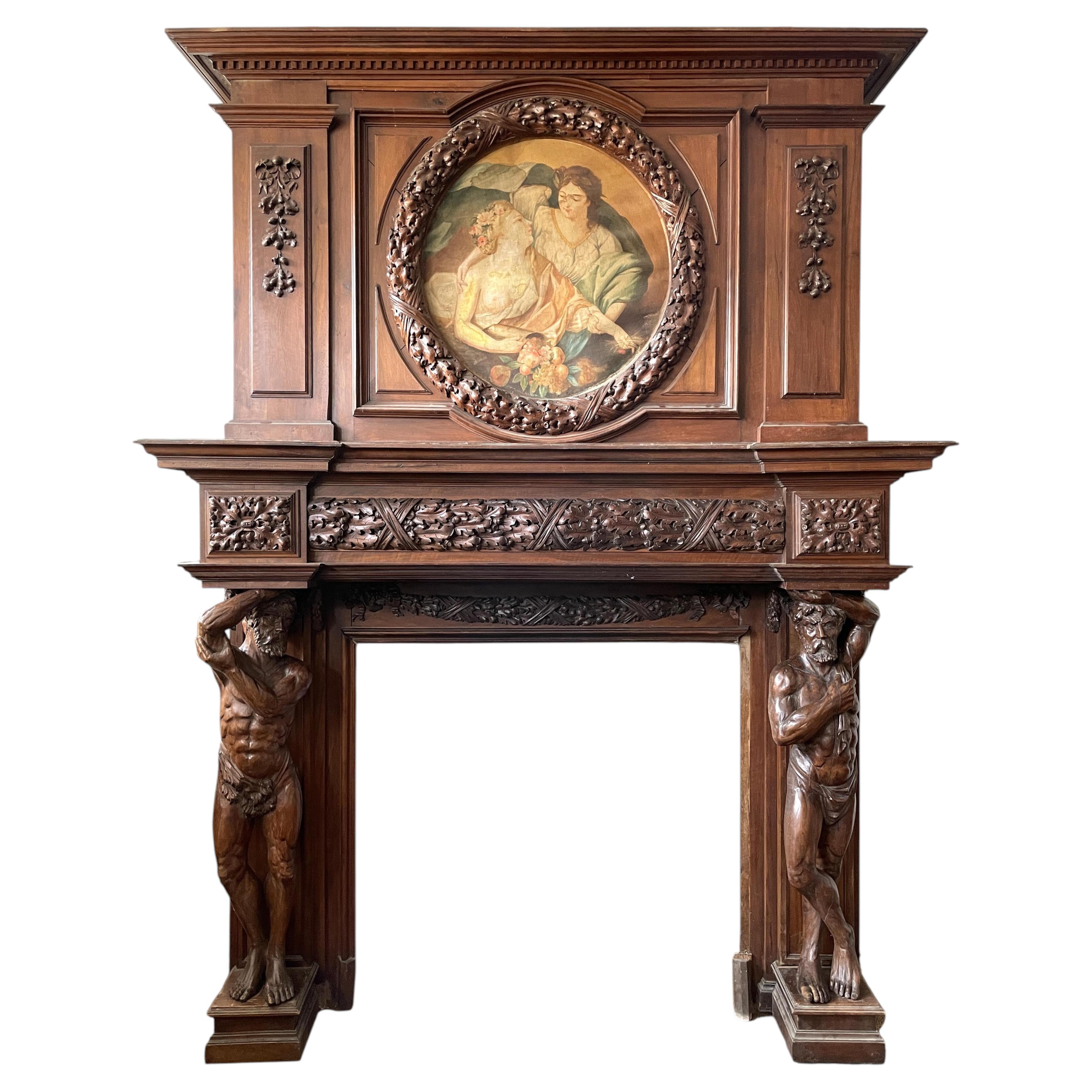 Monumental carved walnut fireplace with atlantes and painted medallion