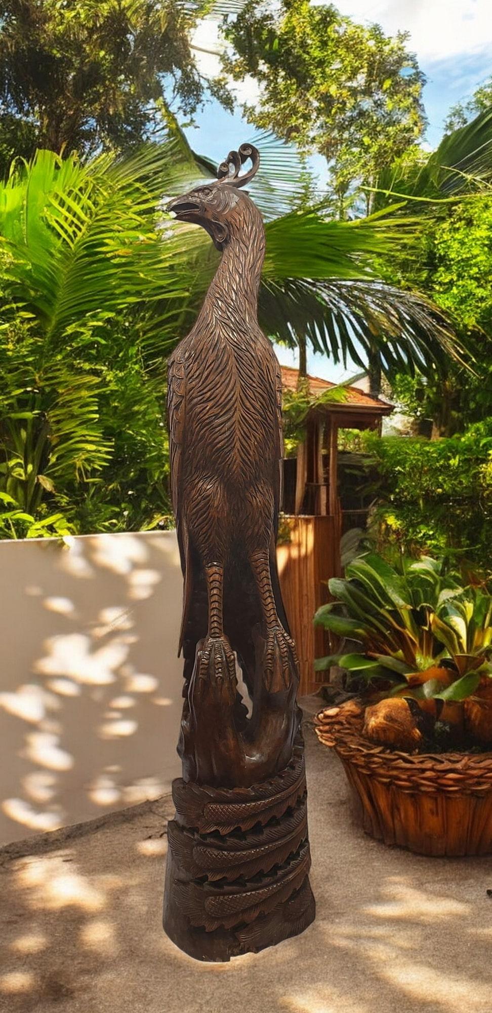 Esta magnífica escultura capta la imponente presencia de un ave casuario con increíble detalle. Tallado a mano a partir de una sola pieza de madera de teca, el artista ha representado con maestría los rasgos distintivos del ave, desde su cascarón
