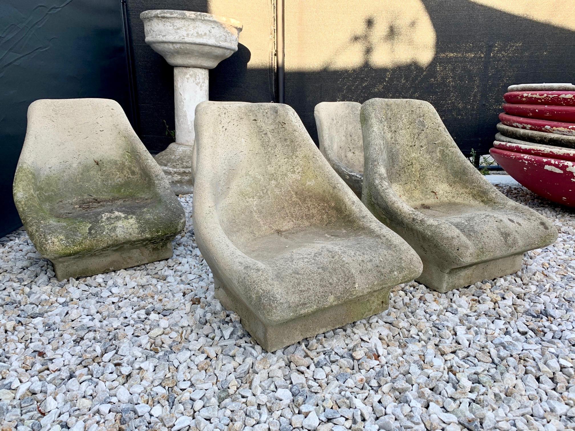 Unusual set of 5 cast concrete chairs. Originally purchased in Los Angeles in the 1980s. Low profile and surprisingly comfortable. Once used around a sunken fire pit. Good patina and coloring. Very sturdy chairs, approximately 200 pounds each. 

3