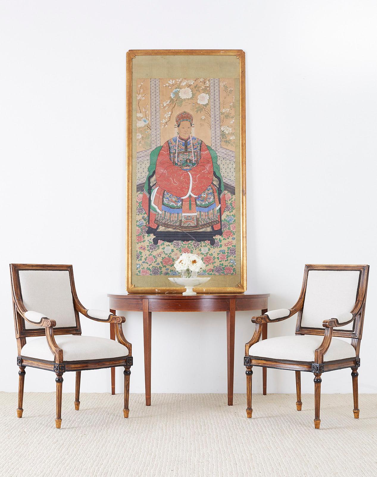 Monumental Chinese late Qing dynasty ancestor scroll portrait painting of a high ranking official or Imperial court matriarch. Features a woman seated in a room wearing an intricately decorated Ming style robe and headdress. The room has open window