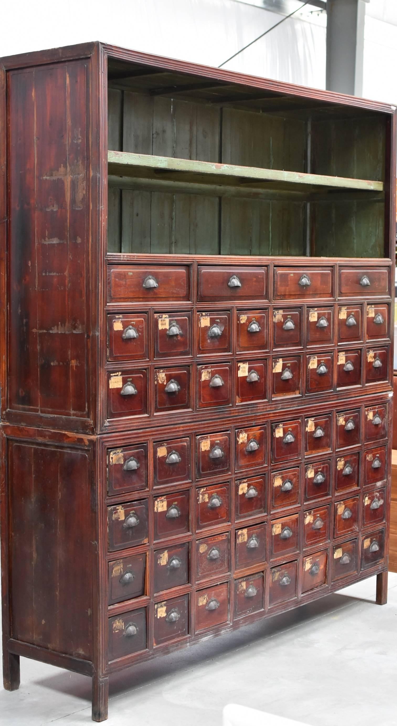 At over 7' tall, over 6' wide, this magnificent cabinet is one of the most impressive Apothecary chests we have seen. There are 52 drawers total. The small drawers have two-section dividers and the large ones have four-sections. An 