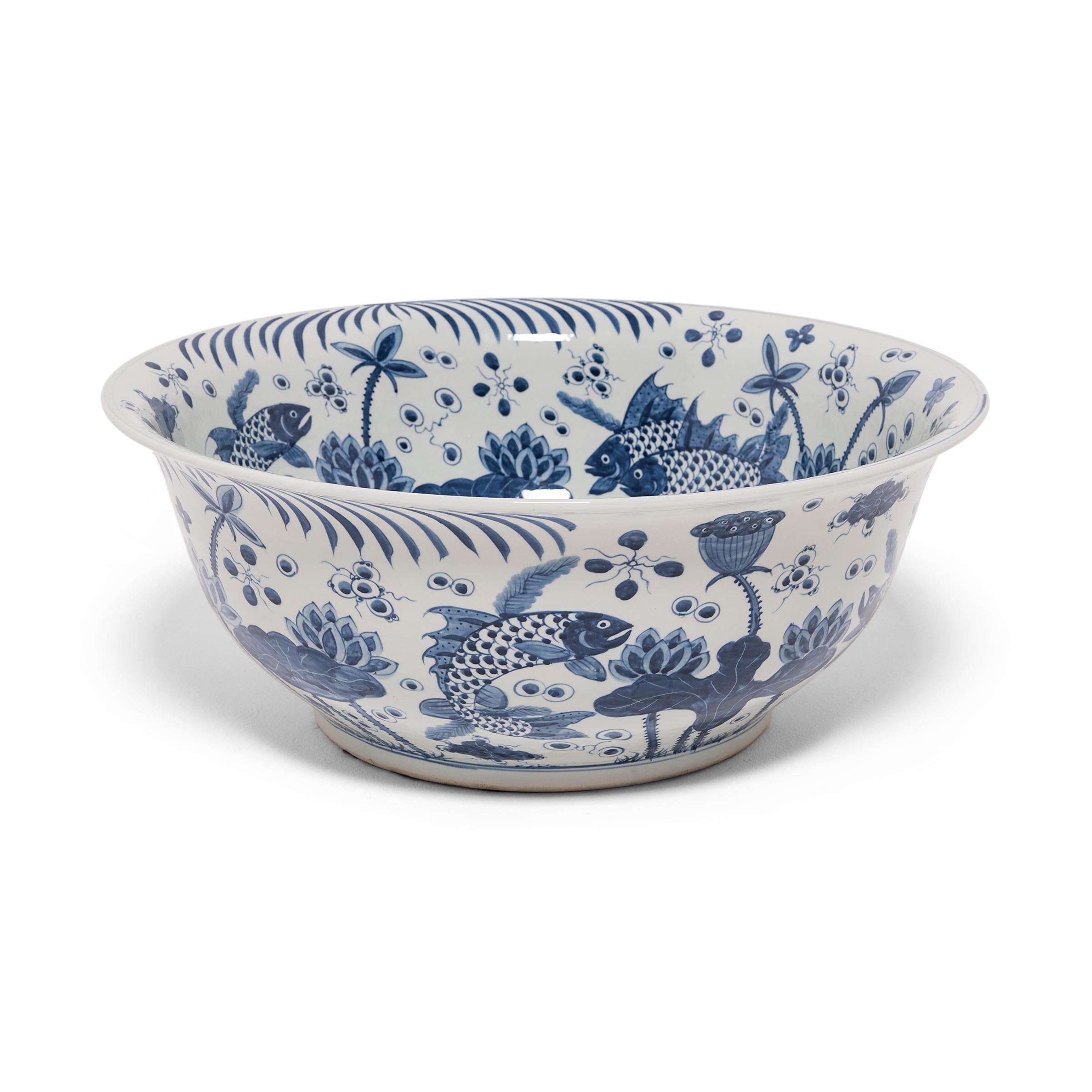 Beautifully rendered with expressive brushwork, the painted decoration on this monumental bowl demonstrates the exceptional artistry of Chinese blue-and-white porcelain. Cast with a cobalt glaze, the bowl is hand-painted with flora and fauna of the