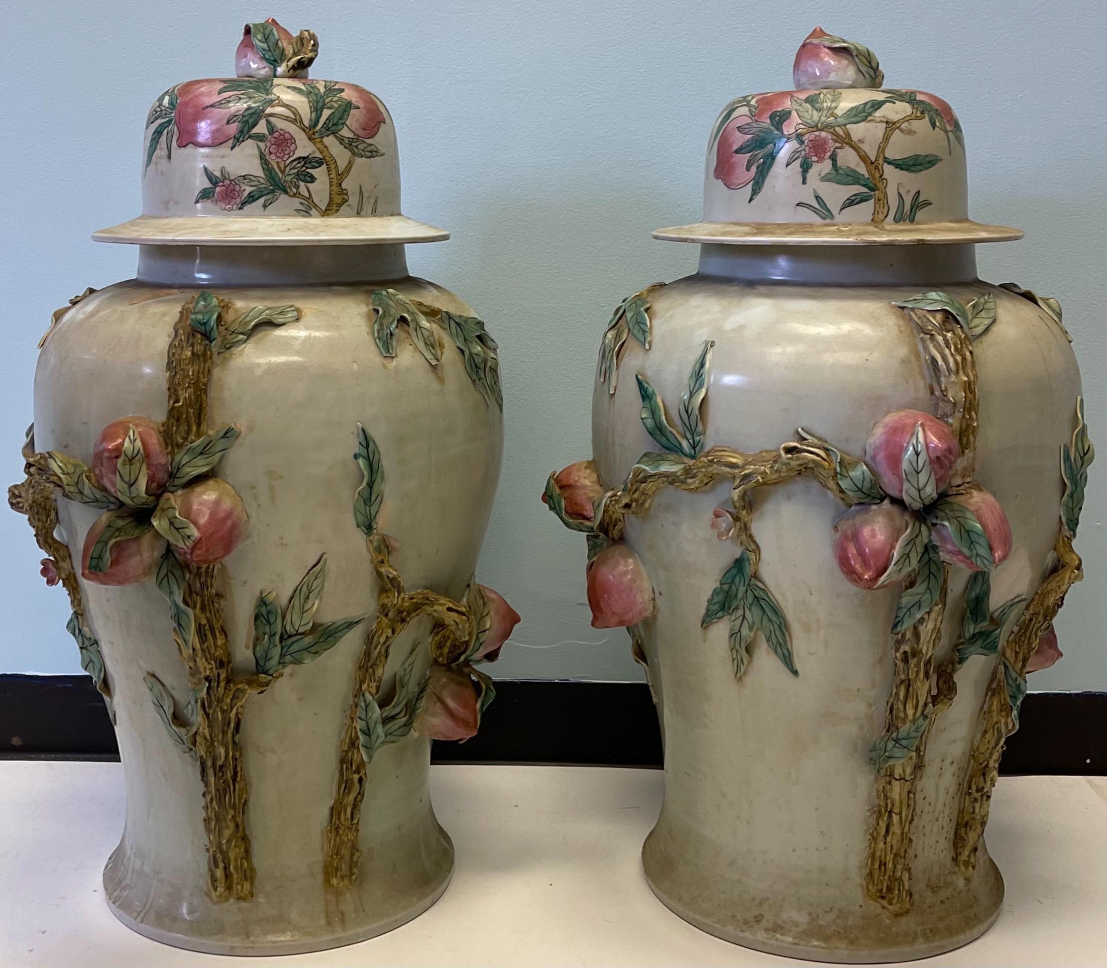 These are wonderful! This pair of Chinese ginger jars are very large! The lids and body are covered in winding faux bois vines and fruit…some sort of plum. I believe them to be Late-century pieces but am unsure of the exact age. Very heavy!