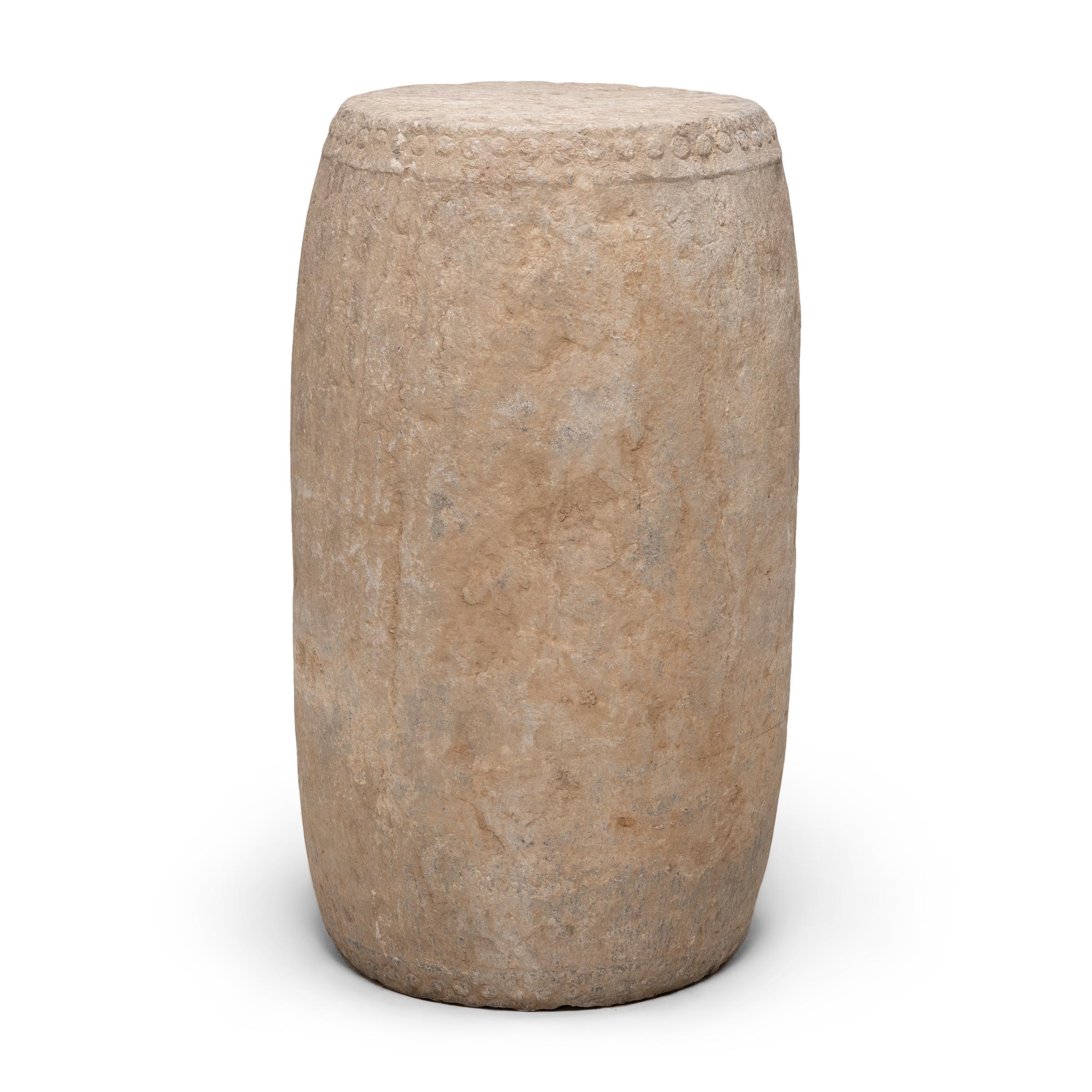 This monumental drum stool was hand-carved from solid limestone by artisans in Shanxi province over two centuries ago. Drum-form stools such as this were traditionally used in gardens and outdoor pavilions where upper class scholars read, wrote,