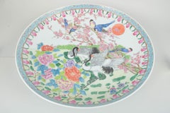 Monumental Chinese wall plate in porcelain with rich hand-painted decoration.