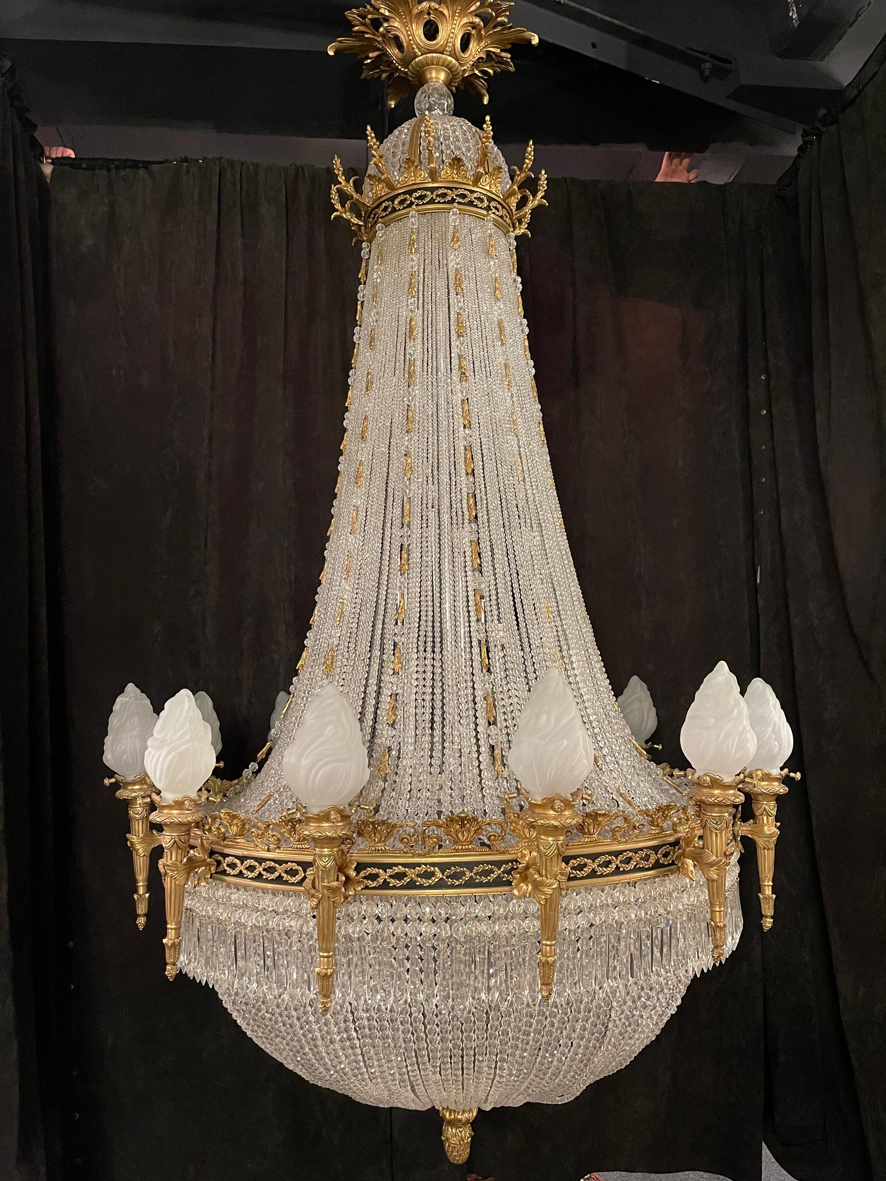 Monumental Classicist ceiling chandelier, crystal brass

Impressive chandelier, richly faceted. Wide body with 12 light arms.
Fine, engraved and cast Bronze. Basket-formed corpus from handcut frenches ball prisms. Connected through wide,