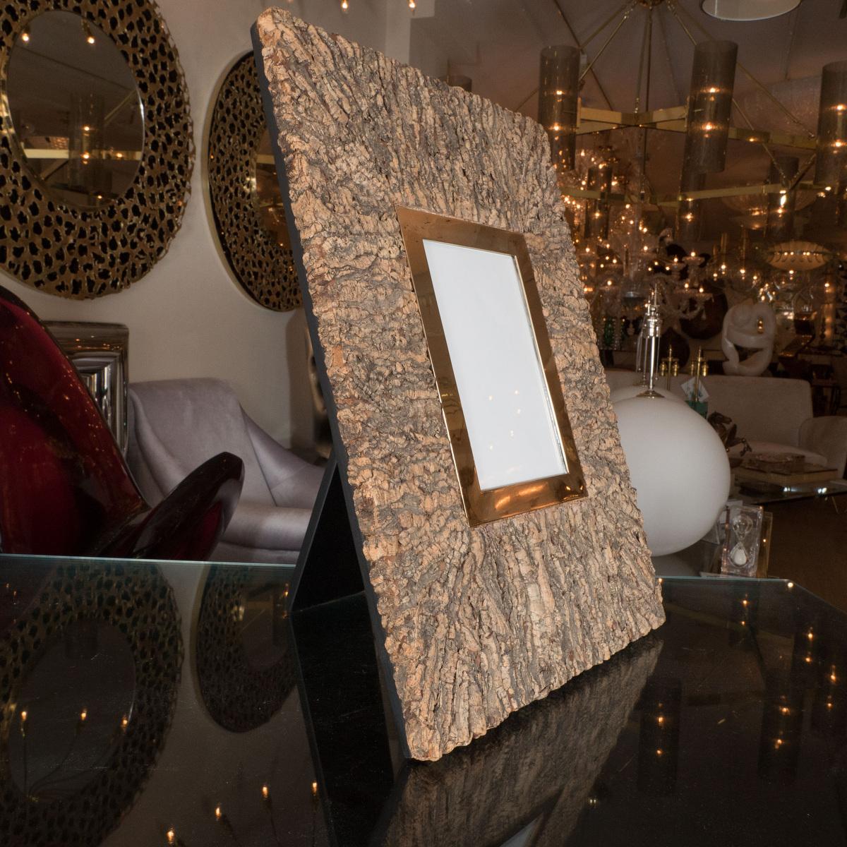 Monumental cork and brass picture frame.
