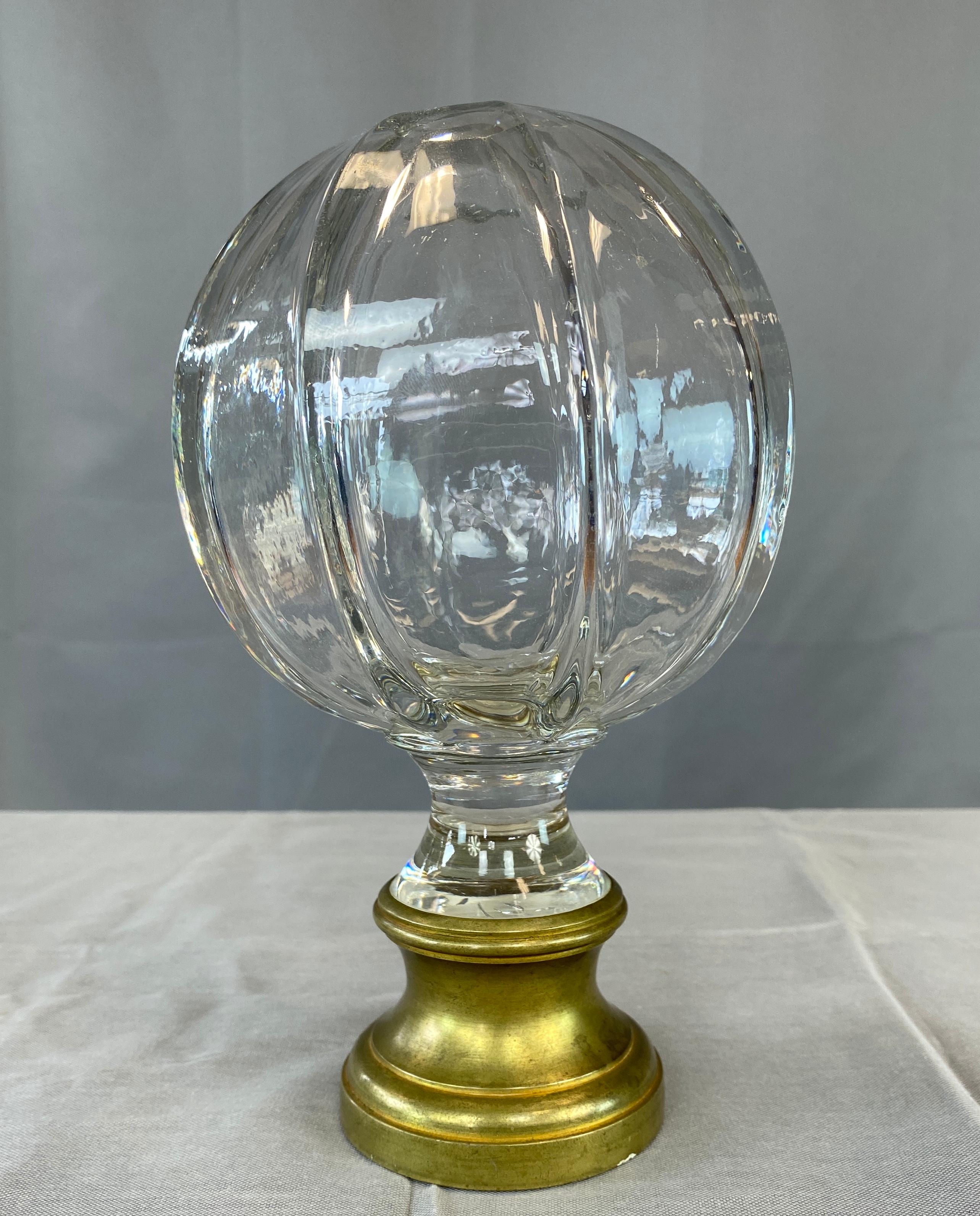 Offered here is a circa early 1900's crystal and brass newel post finial/stair ball (aka boule d'escalier).
Extra large 8 side crystal ball, set into a brass stem. 
  