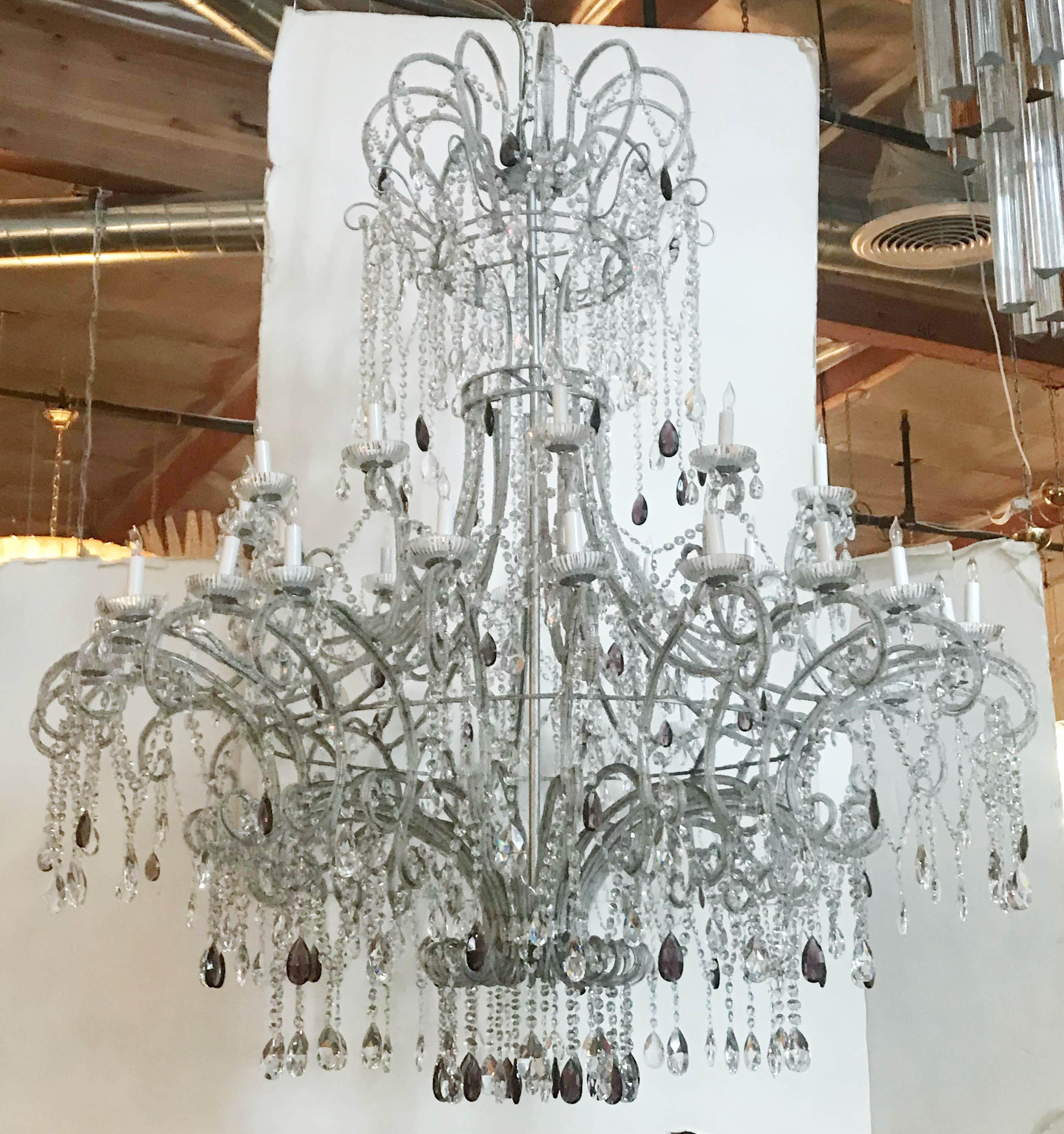 Vintage monumental Italian beaded Florentine chandelier with clear and amethyst faceted crystals mounted on wrought iron silver painted frame / Made in Italy, circa 1970s
36-light arranged in 2 tiers / E12 type / max 40W each
Measures: Diameter 60