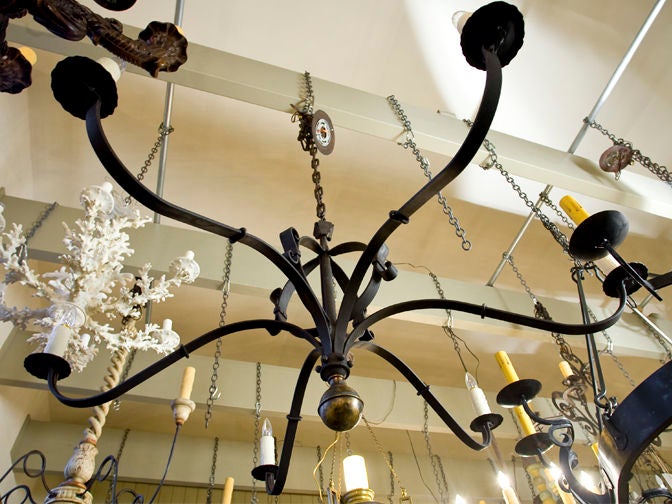 Our exclusive design, the Defiance is a large hand-made iron chandelier with six sockets. Comes with a handmade iron chain and canopy. Large bass ball finial at the base. Newly wired in the USA with all UL listed parts. Multiples available. Price is