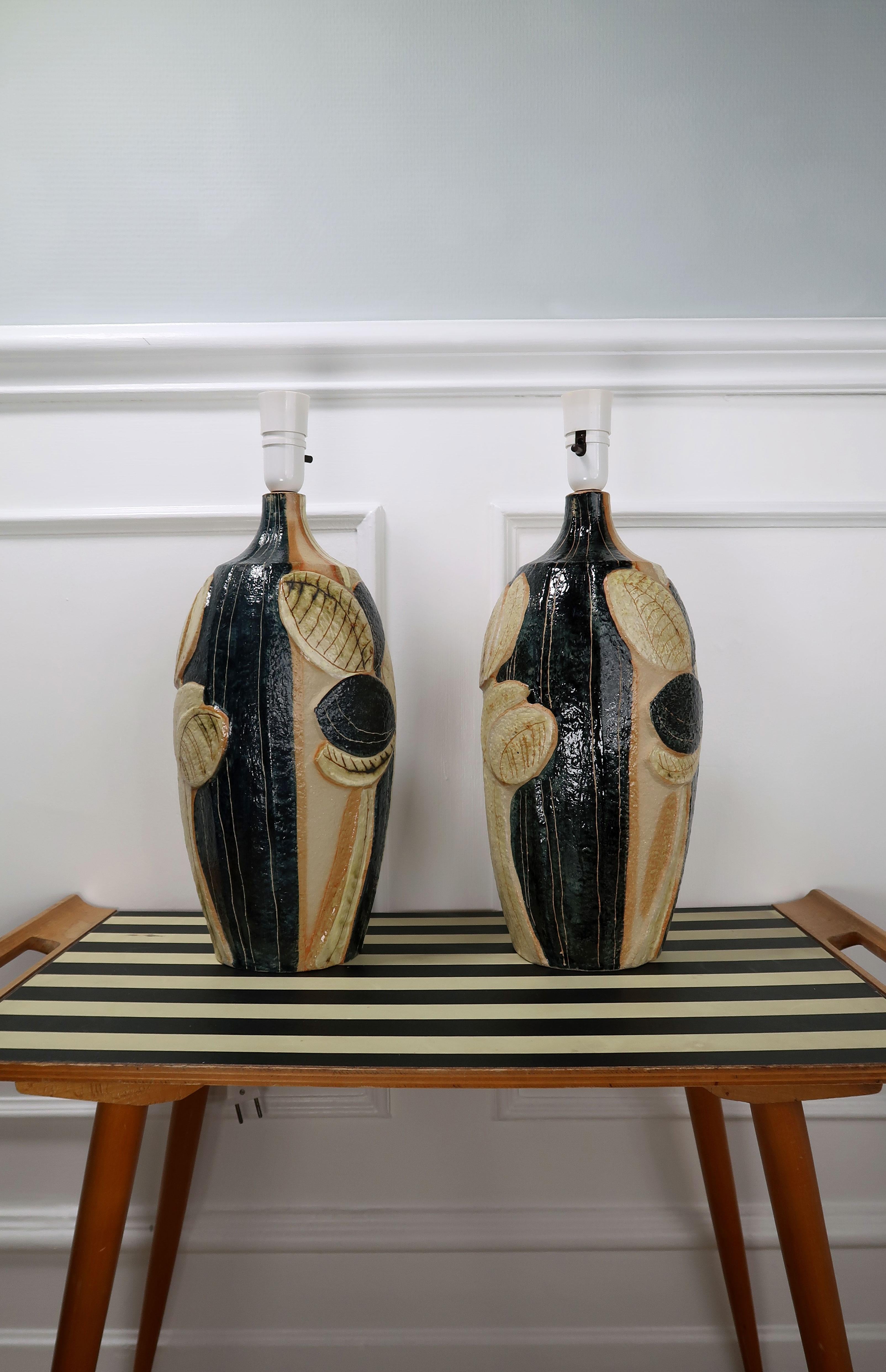 Stunning and rarely seen set of large Scandinavian Mid-Century Modern handmade stoneware table lamps by designer Noomi Backhausen for Danish Søholm Stentøj. Hand painted big graphic leaves on slender stems in shiny black, creamy yellow and warm