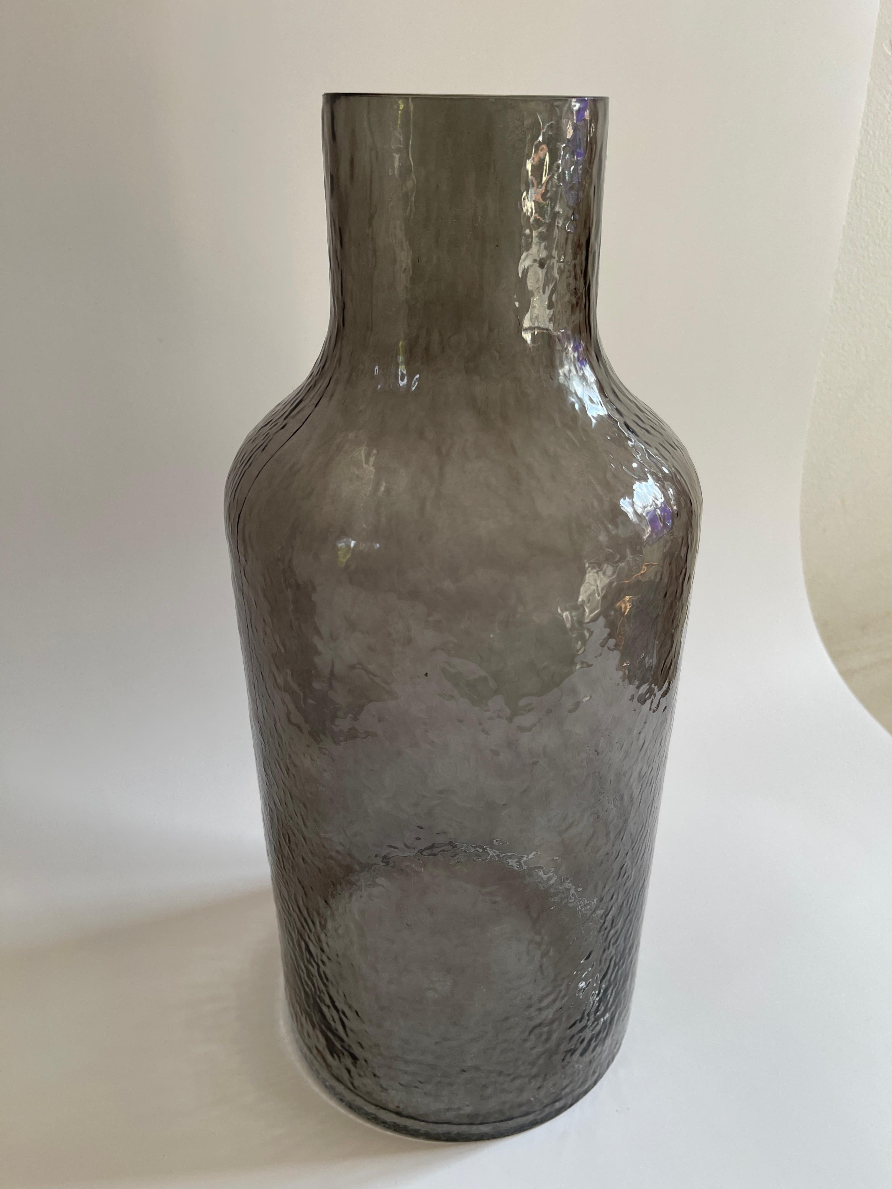 Monumental Danish modern smoke glass bottle form vase with rippled texture,  The textured glass filters the light, crating a wonderful effect.