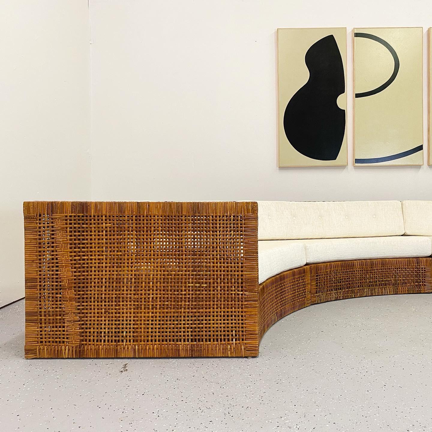 An exceptional and rare four-piece sofa designed by Danny Ho Fong for Tropi-Cal. This is the only example of this sofa on the market. Beautiful woven rattan over mahogany frame. Massive in scale at fourteen feet across.