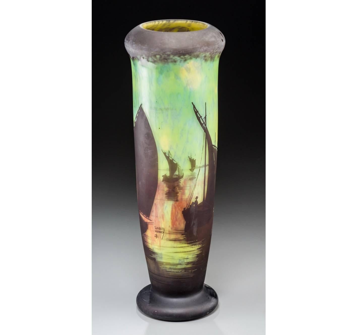 An enormous Daum Nancy acid etched, cameo overlaid glass vase with a serene scenic of French fisherman with lateen sail boats cameo etched in browns, green, yellow, orange and red, (7 sailboats)

Circa 1900. 

Signed in Cameo: DAUM NANCY with Cross