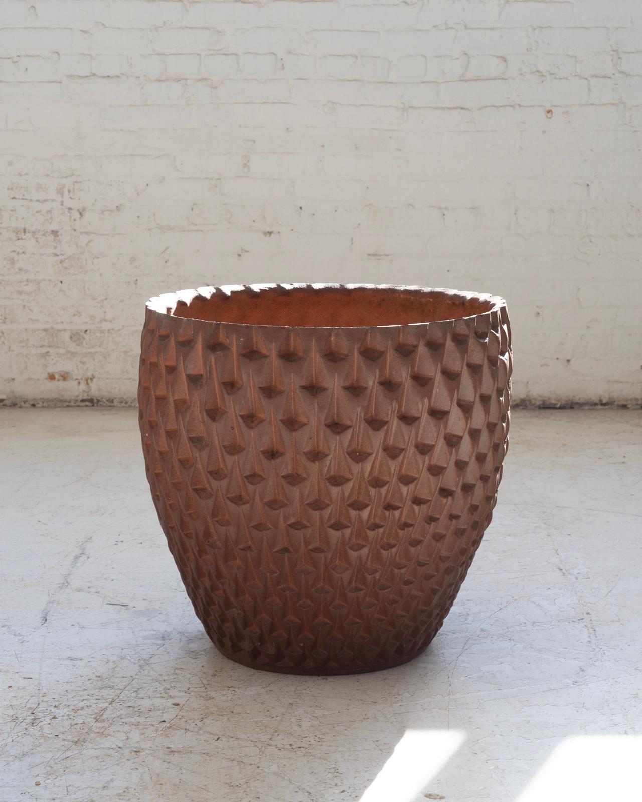 This monumentally sized “Phoenix-1” planter by renowned ceramicist David Cressey makes an impressive statement with its commanding scale and richly hued glaze. Crafted in a warm, clay-toned red, the subtle variations in color lend the surface a