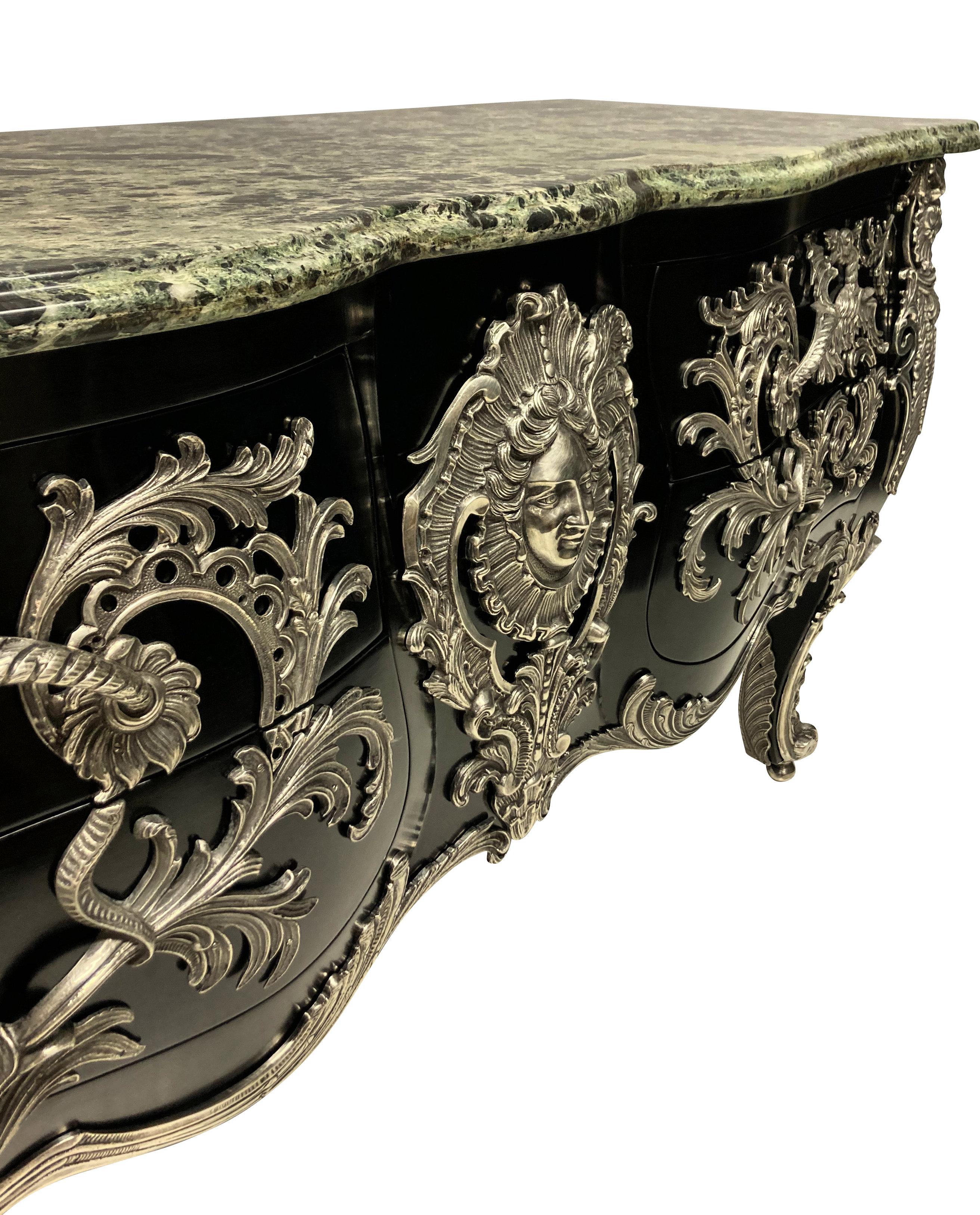 A monumental French commode a vantaux after François Linke's Antoine-Robert Gaudreaux model. The serpentine verde alpi marble top above a rocaille-framed Apollo mask and two pairs of serpentine drawers mounted with dragon and acanthus handles. The