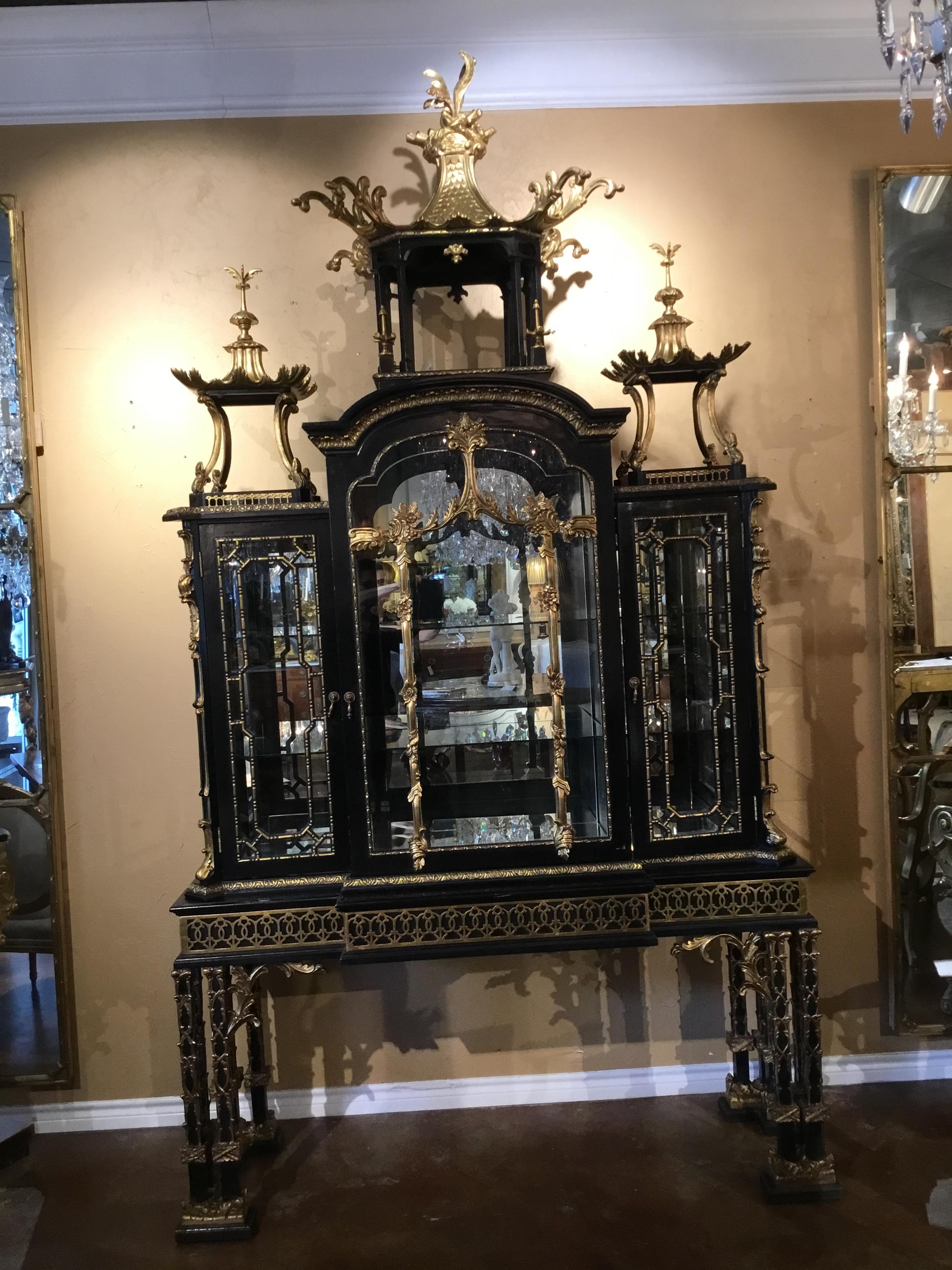 Monumental replica of Thomas Chippendale’s Kenure cabinet in the Chinese Chippendale taste,
With a large open pagoda-form structural crest flanked to either side by smaller like structures,
The central section fitted with a single arched door