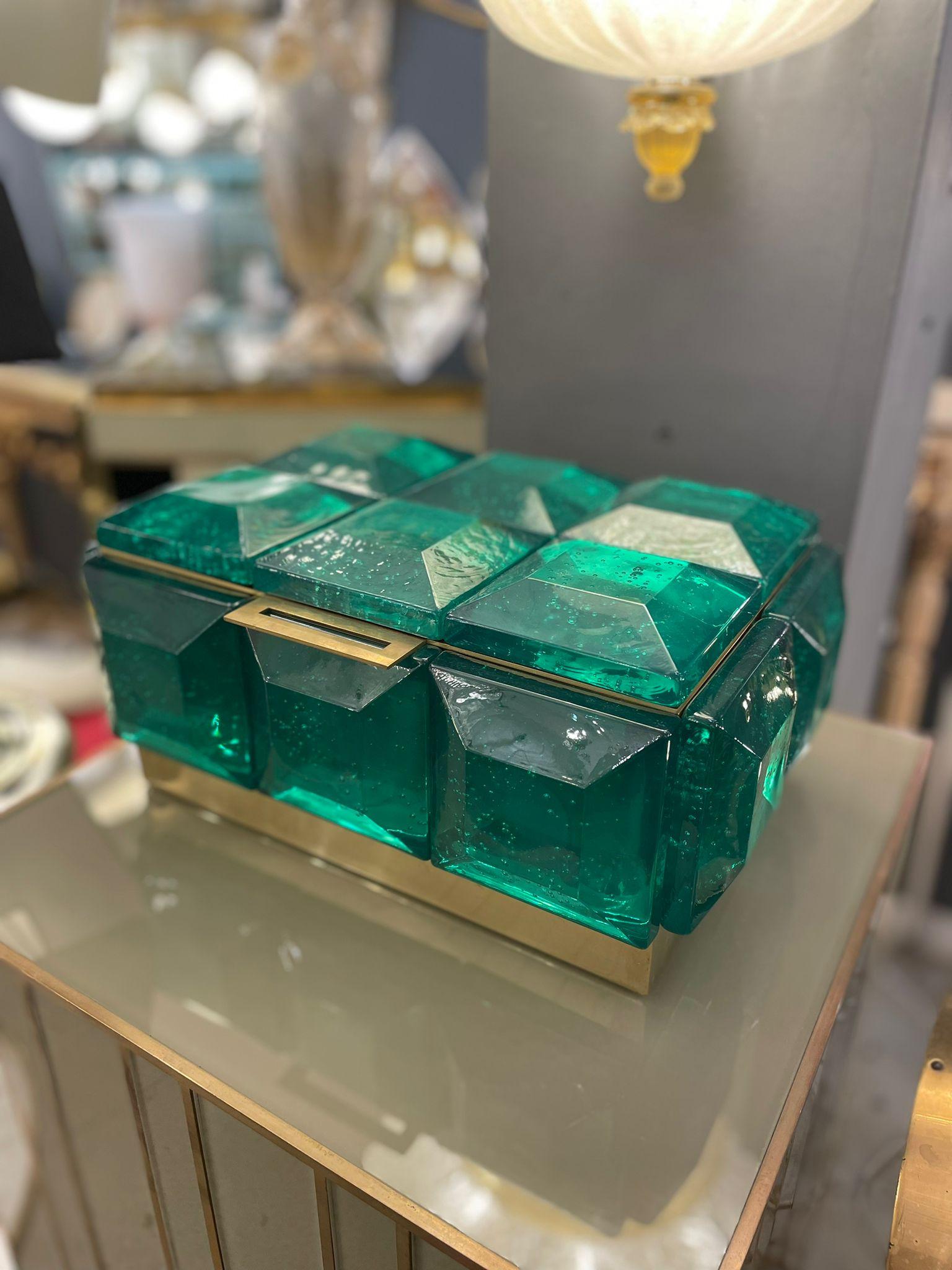 A monumental box in emerald Murano glass with polished brass inner core.