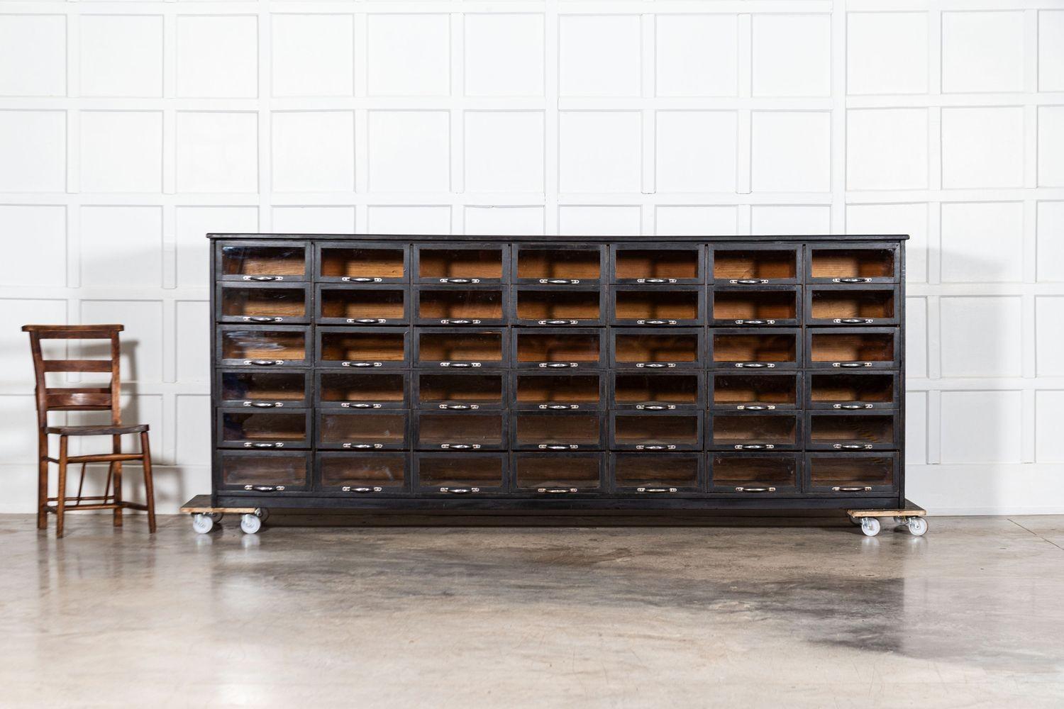 circa 1900
Monumental English Ebonised Pine Glazed Haberdashery Drawers
sku 1864
W278 x D43 x H109 cm
Weight 130 kg