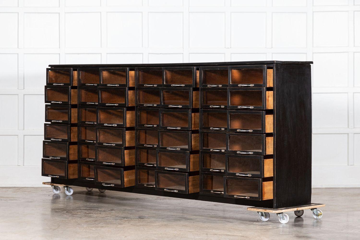 20th Century Monumental English Ebonised Pine Glazed Haberdashery Drawers For Sale