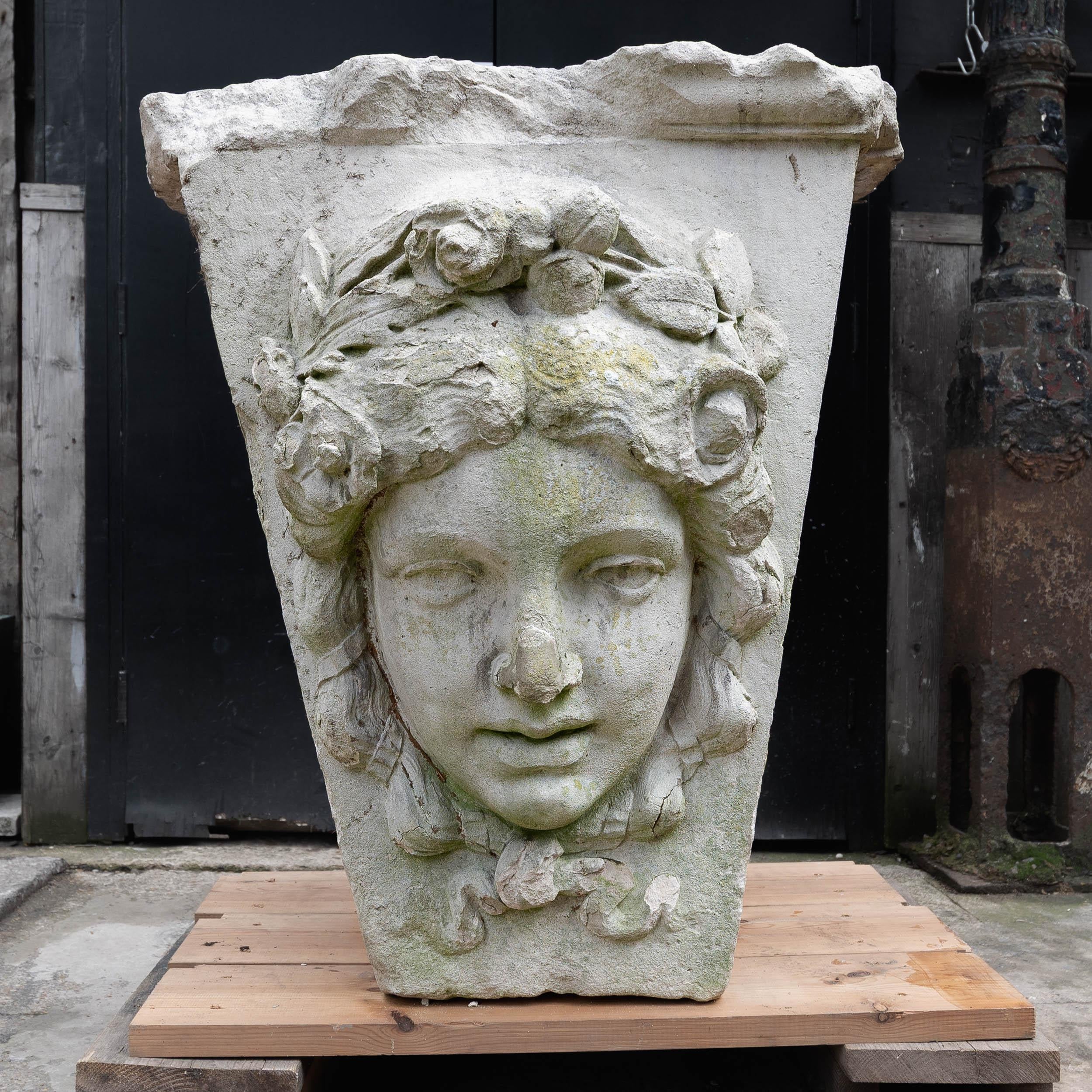 An enormous, English carved Portland Stone keystone, Edwardian c.1905, with a female mask to the front. 

Of astonishing and imposing scale, wear as expected, repaired nose. 