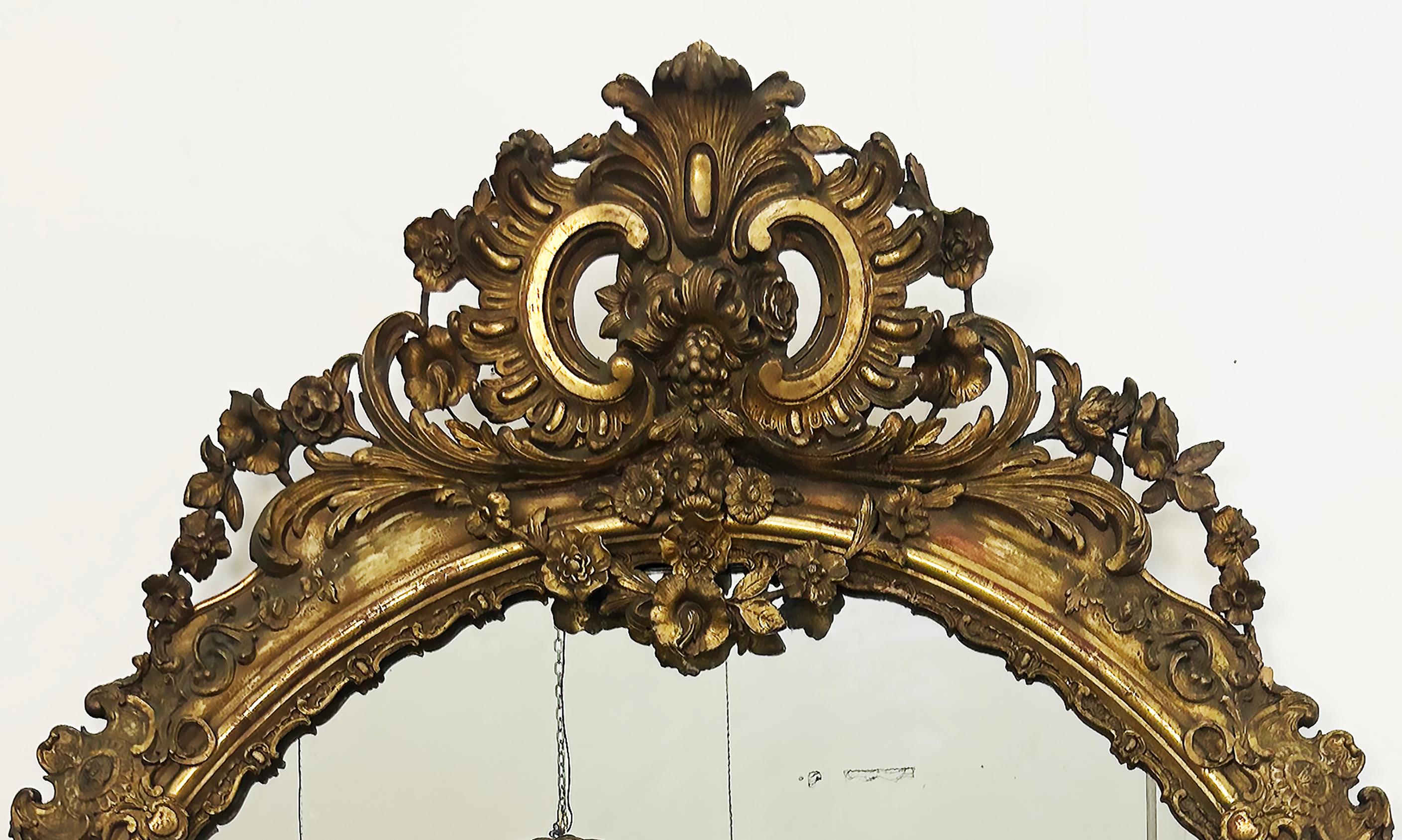 Monumental European Oval Giltwood Mirror, Late 19th-Early 20th Century

Offered for sale is a late 19th or early 20th-century monumental oval gesso and giltwood mirror from Europe. The crown of the mirror is embellished with ornate and detailed