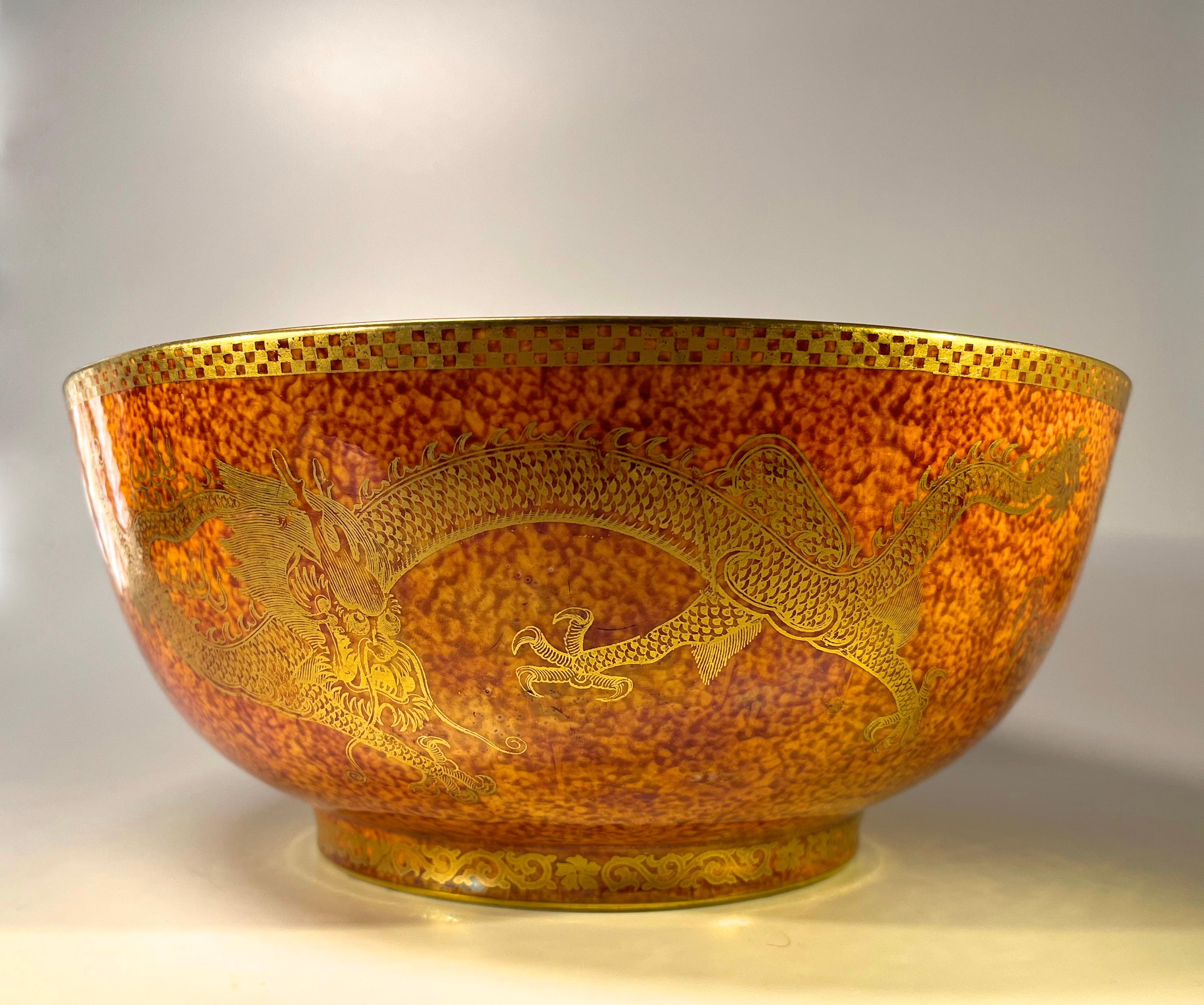 Daisy Makeig-Jones for Wedgwood, Fairyland Lustre substantial round bone china centrepiece bowl
The exterior is exquisitely adorned with animated gilded dragons on a rich copper orange mottled background. Gilded decorative edging to foot and