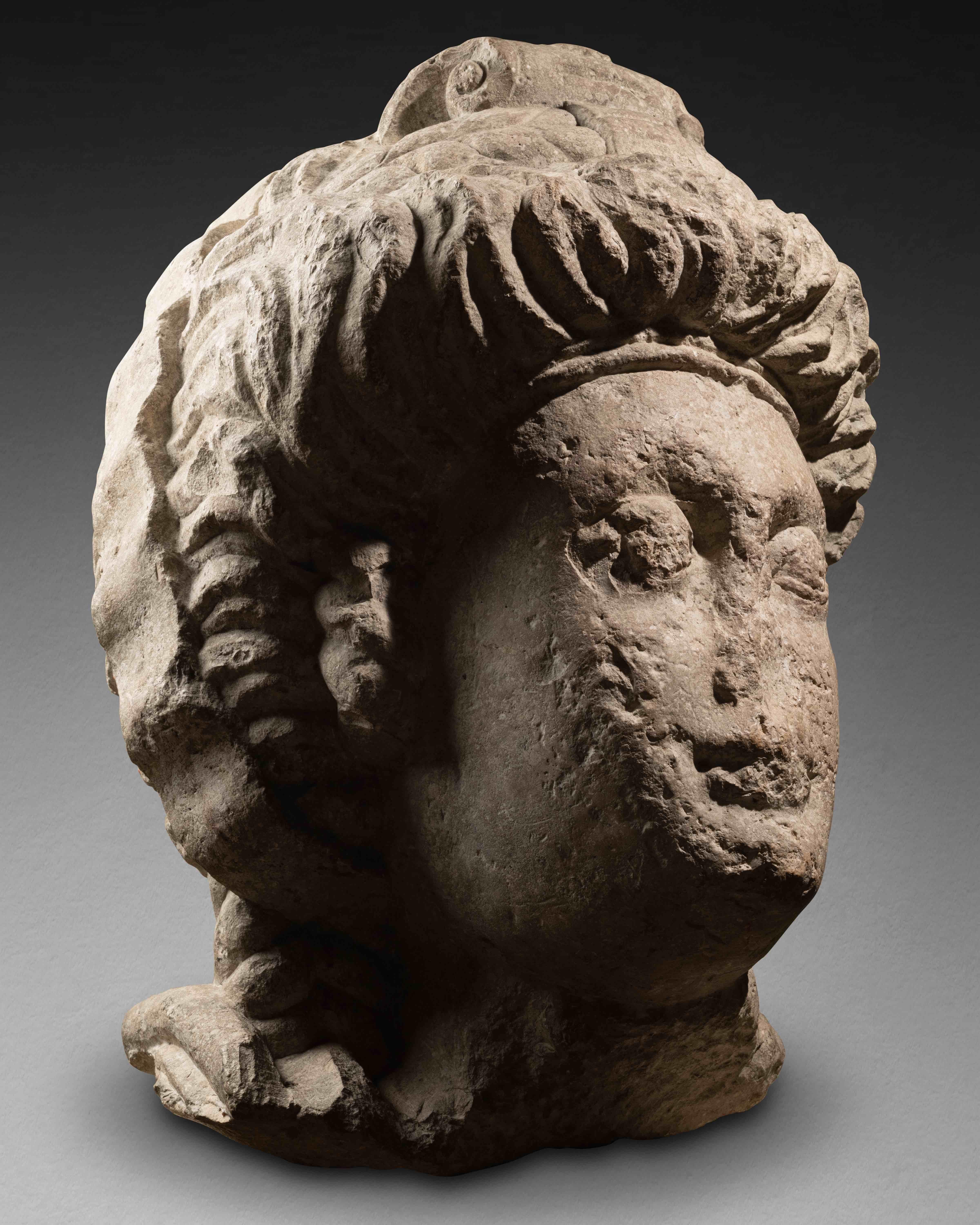 Very large feminine head crowned by a tiara
Roman period, 3rd - 4th century AD
Eastern provinces of the Roman Empire (Palmira?)
gray basalt
H 55 cm

Old collector's label visible in the lower right side.

Female head with idealized features. Despite