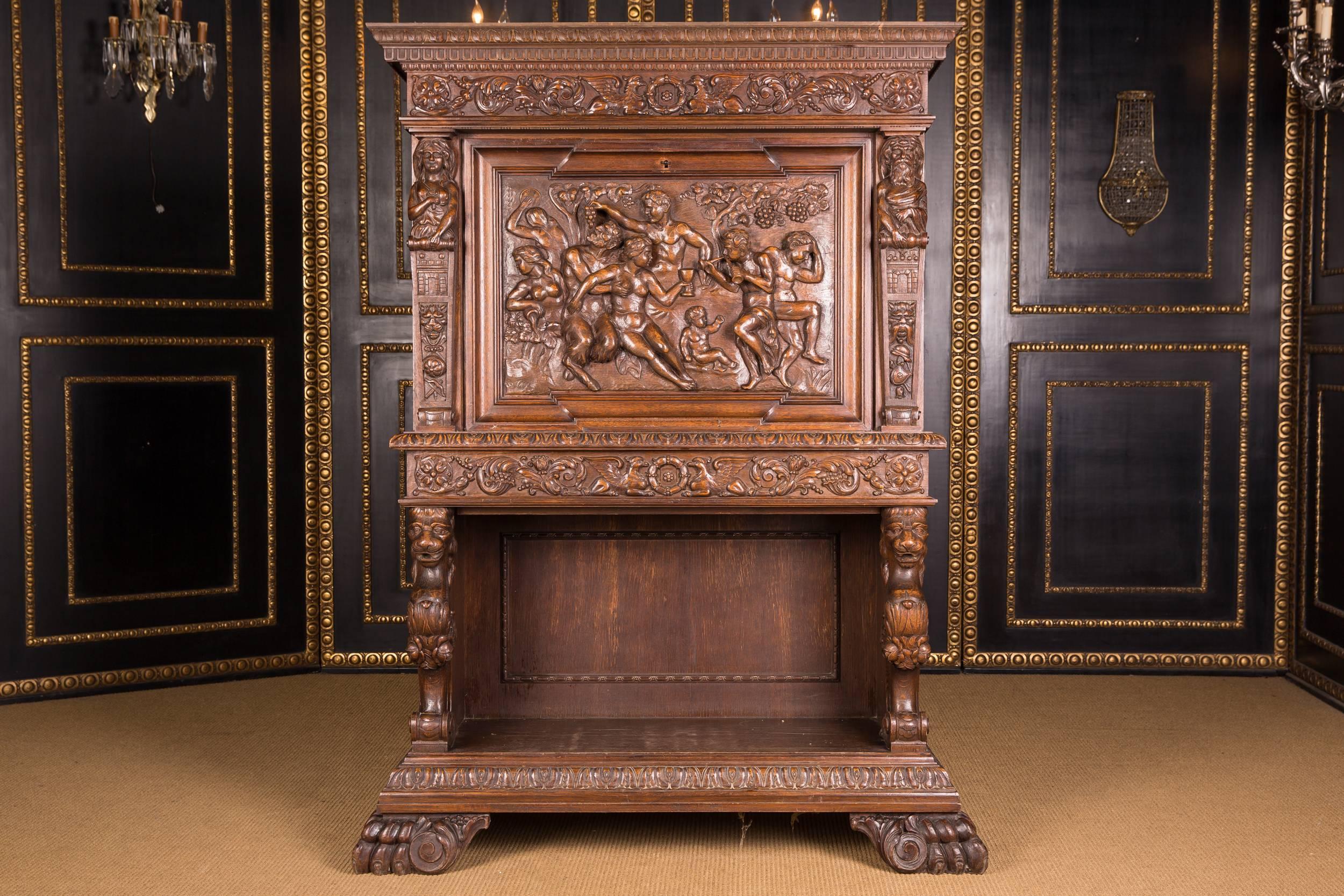 Fully carved front, full plastic figural representation with different scenes.
On the right and on the left plastically carved figures (female or male). Beneath this, open compartment, flanked by two carved lions. Legs end in paw shapes.