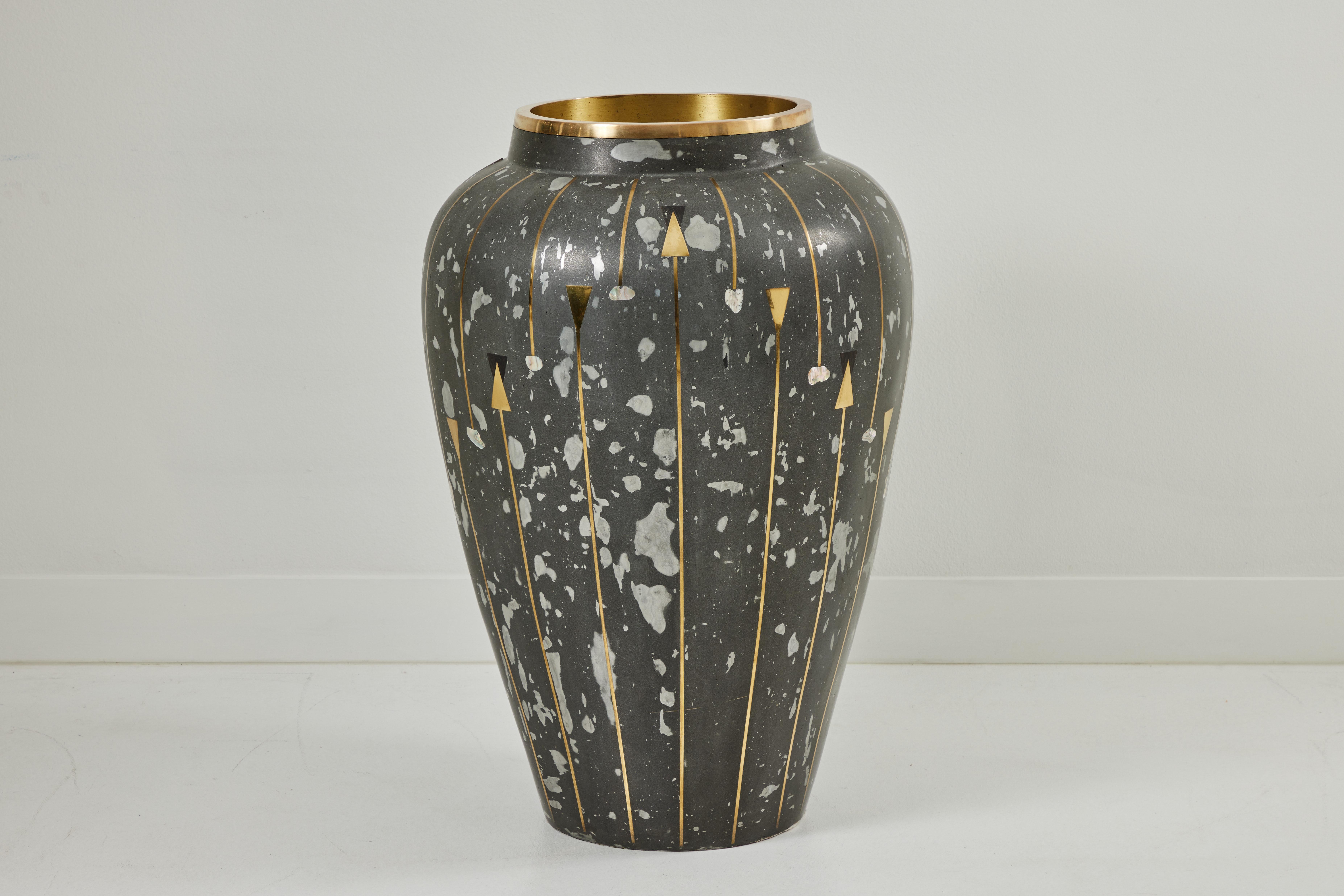 These spectacularly oversized composite cast urns boast a height of 40 inches and a diameter of 26 inches. Fabricated in Glasurite, these urns feature brilliant inlays of ebony, mother of pearl, and polished brass. Each urn is unique with it's own