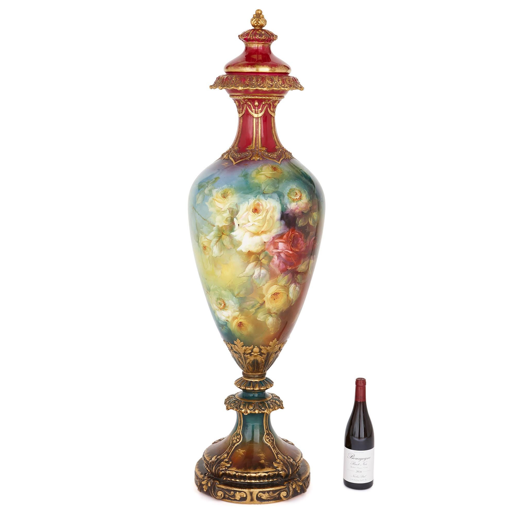 This porcelain vase is magnificent in both its scale—it measures an impressive 1m 25cm (49 inches)—and its Fine painted decoration. The vase was crafted in the early 20th Century by the prestigious Royal Bonn factory. Founded in 1836 in Germany by