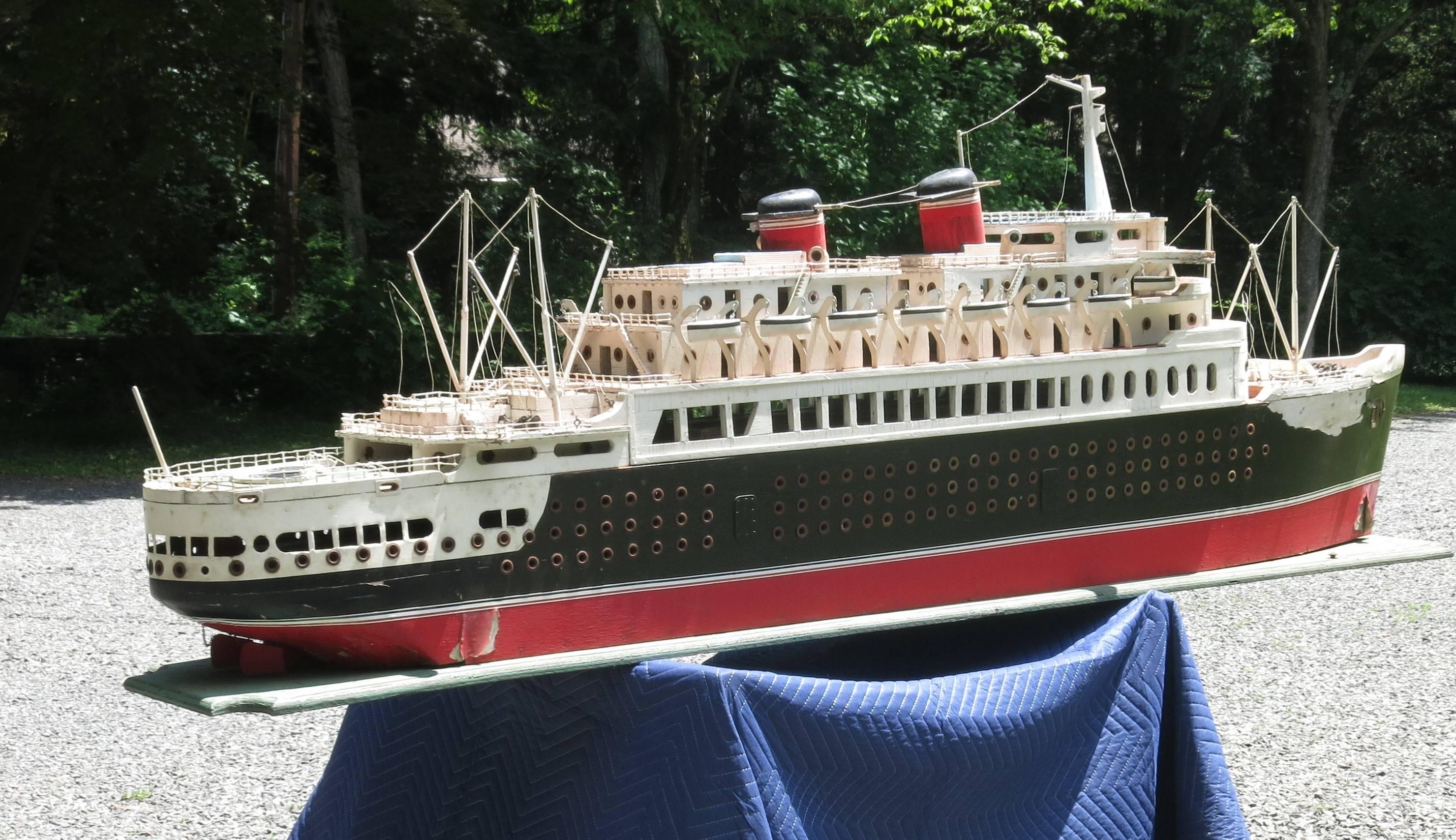 Monumental ocean liner,  ship model from the 1950s. A piece of handmade folk art made to depict  ships that crossed the Atlantic. It is 8 feet long x 33 