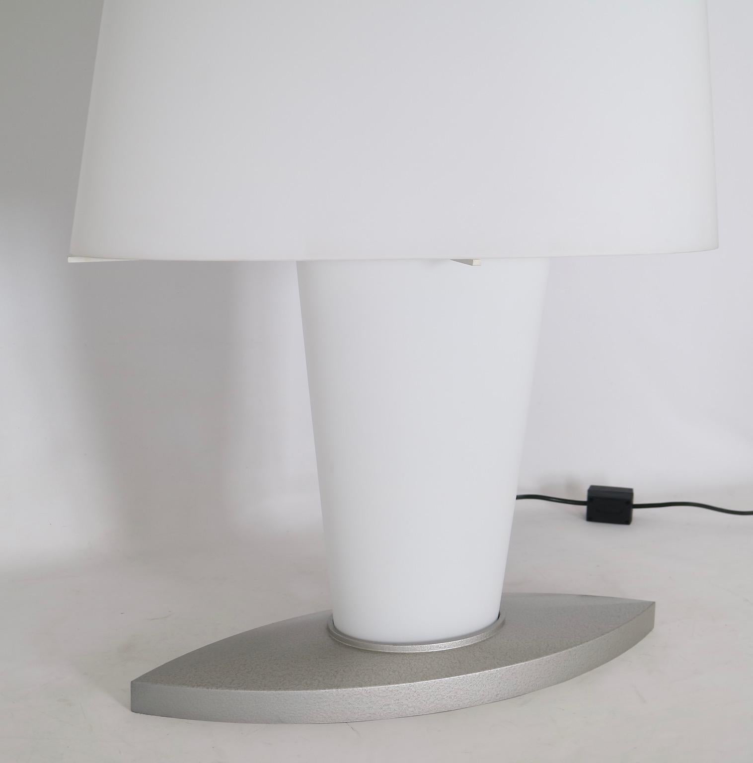 Monumental Daniela Puppa Fontana Arte double switched table lamp in frosted white glass. Designed in 1991, this lamp allows for one to light the top diffuser, bottom diffuser or both simultaneously. The lamp is oblong in shape which is accented by