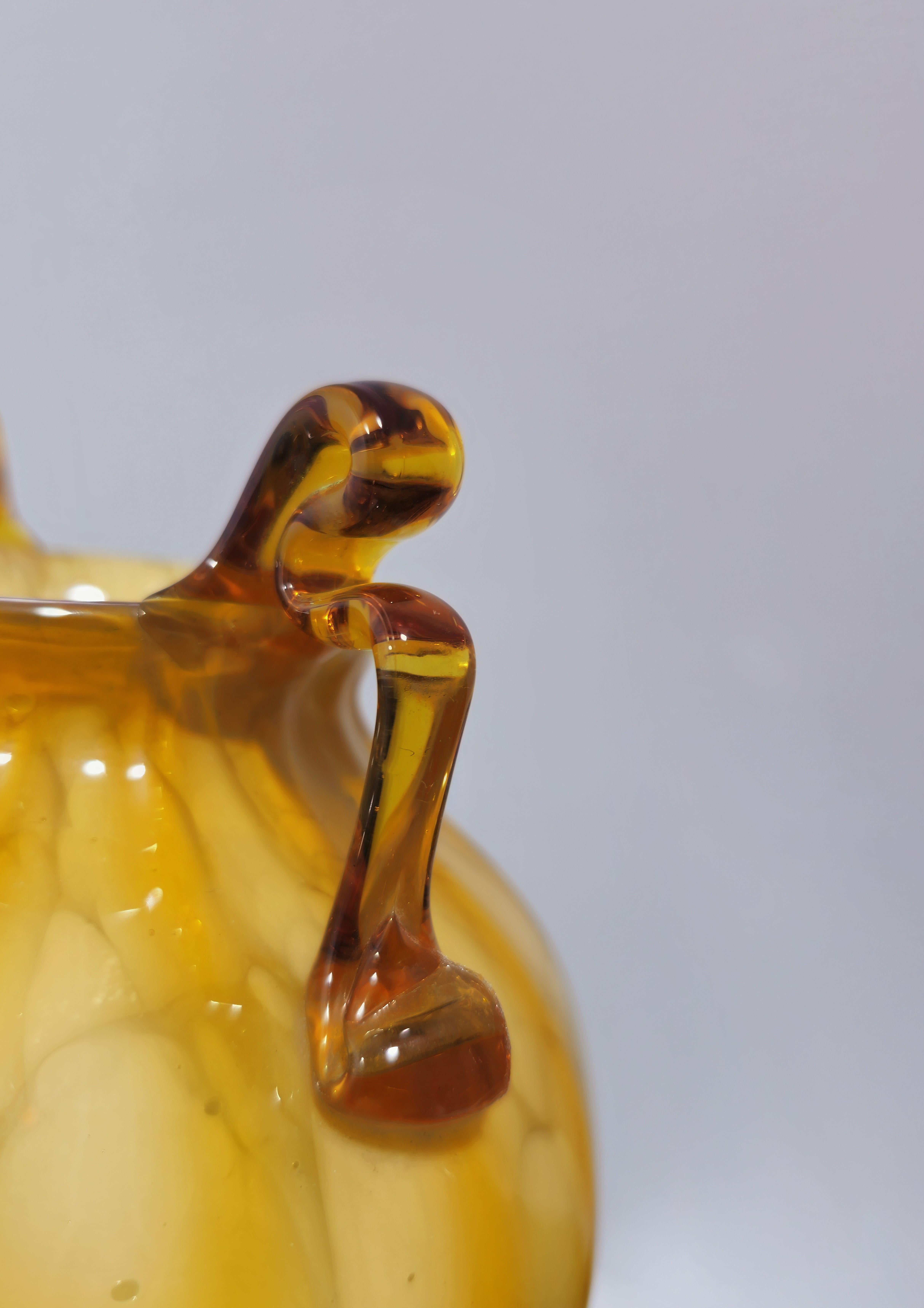 Attributed fratelli Toso
Rare vase with two curly handles. 1930s/1939s. Transparent straw-colored blown glass decorated with milky spots. Double neck vase, decorated with bands. Truly a stunning piece for any environment.  Please watch the video and