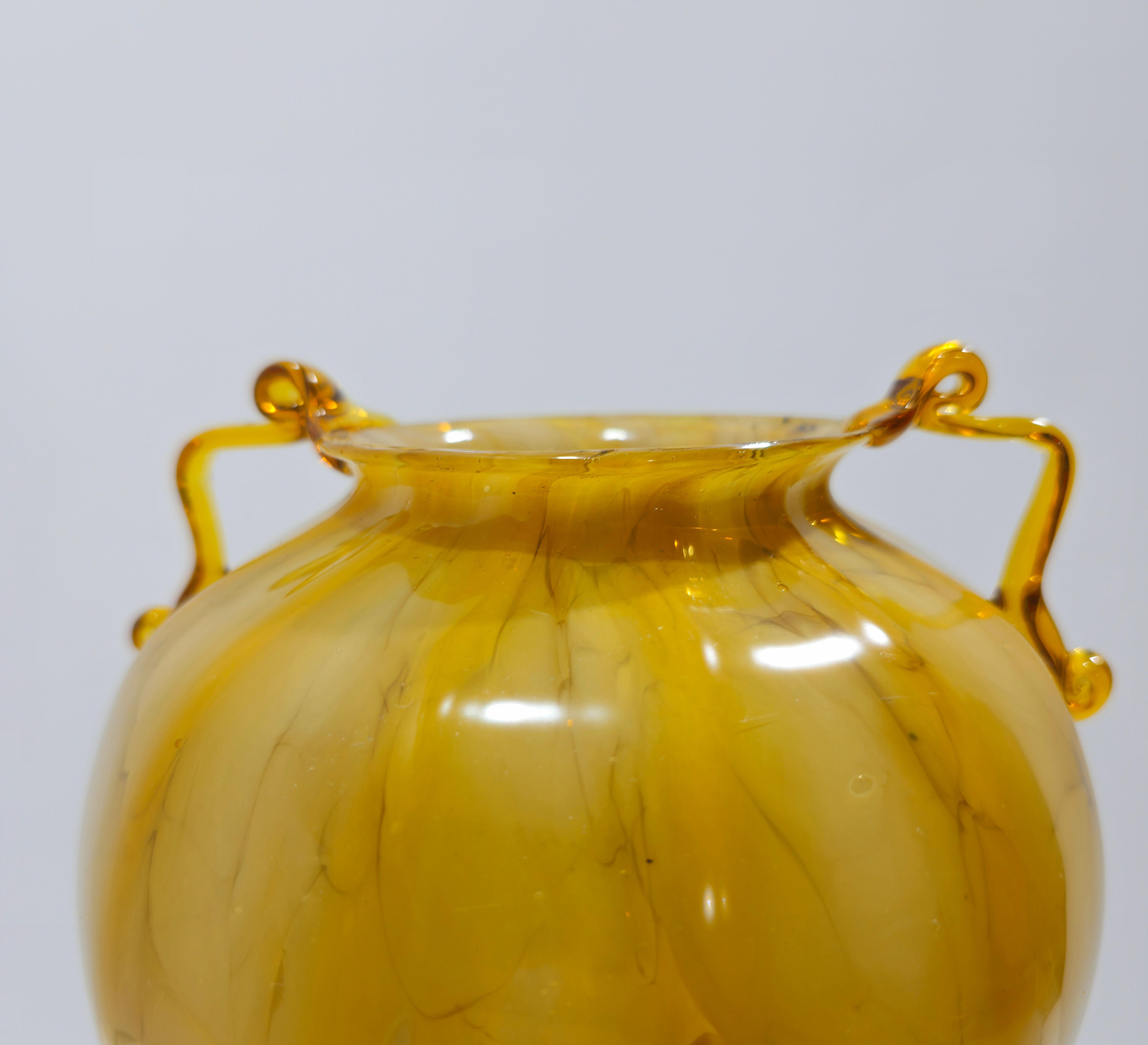 Attributed fratelli Toso
Vase with two curly handles. 1930s/1939s. Transparent straw-colored blown glass decorated with milky spots. Double neck vase, decorated with bands. Truly a stunning piece for any environment.  Please watch the video and