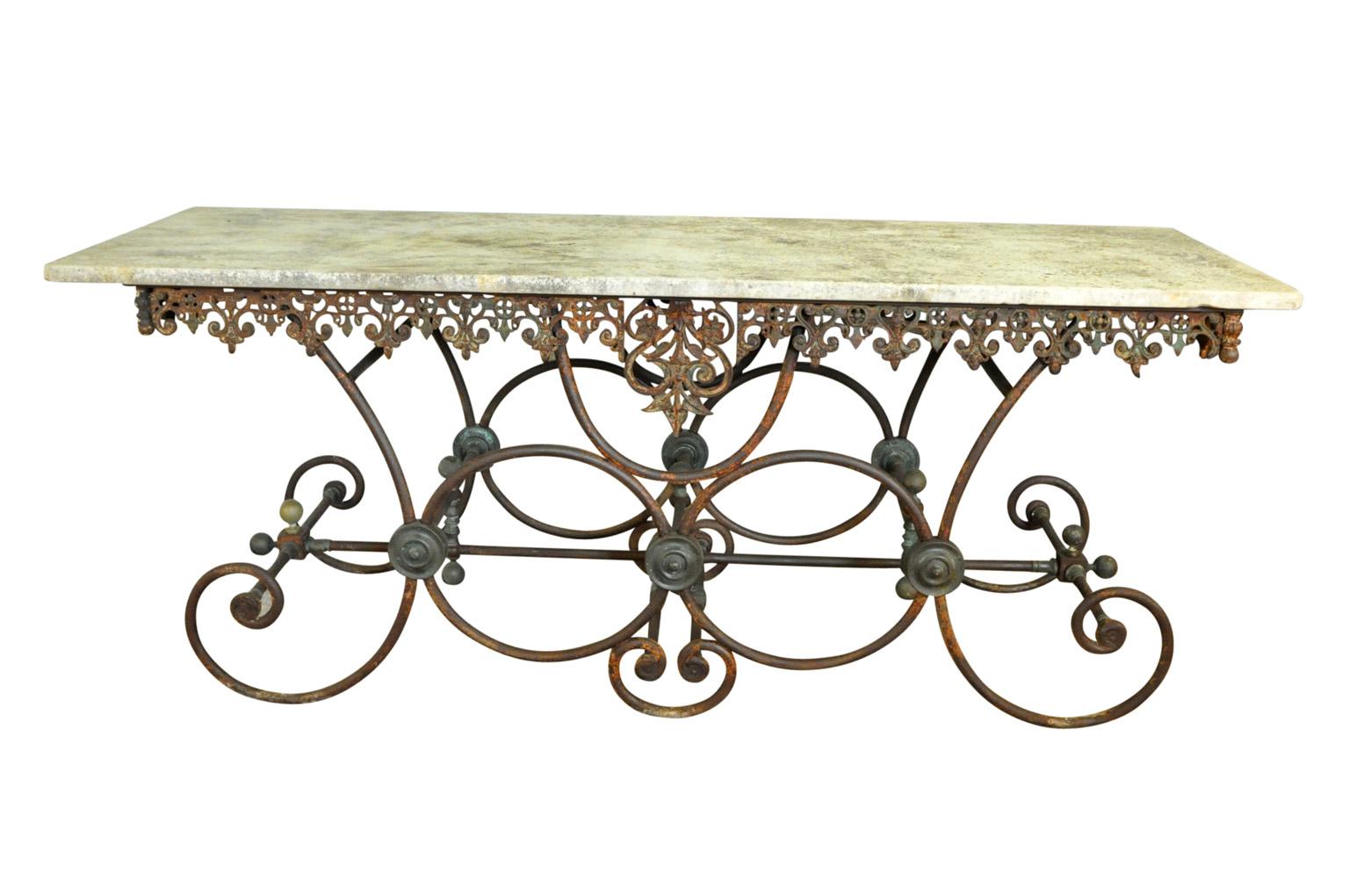 Outstanding and monumental butchers table from the Provence region of France. Soundly constructed with a beautifully cast iron base with its original marble top. Excellent quality and fabulous patina. Wonderful as a kitchen island, console, garden