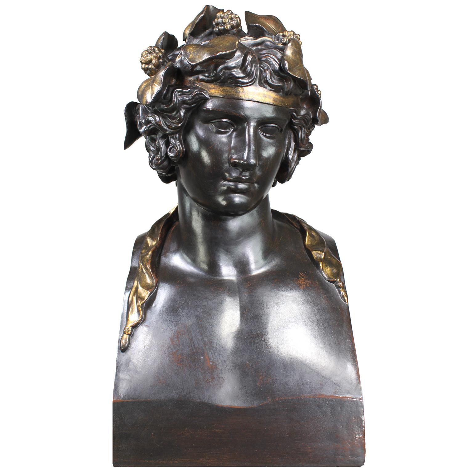 A Monumental French 19th Century Patinated and Parcel Gilt Cast-Iron Bust of 'Head from a Statue of Antinous as Dionysus' Wearing a Wreath of Ivy - Roman Bacchus, God of the Wine, after the Greek models of the mid-4th century BC. Bust. This