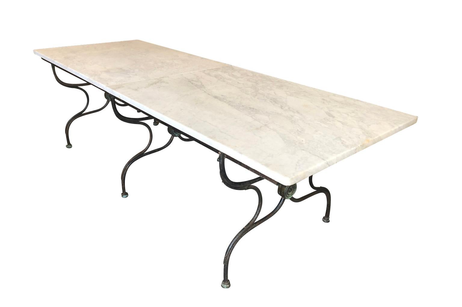 An outstanding and monumental garden dining table from the Provence region of France. Soundly crafted from iron and a wonderful Carrara white marble top. The top is in 2 pieces. Perfect for interior or exterior dining.