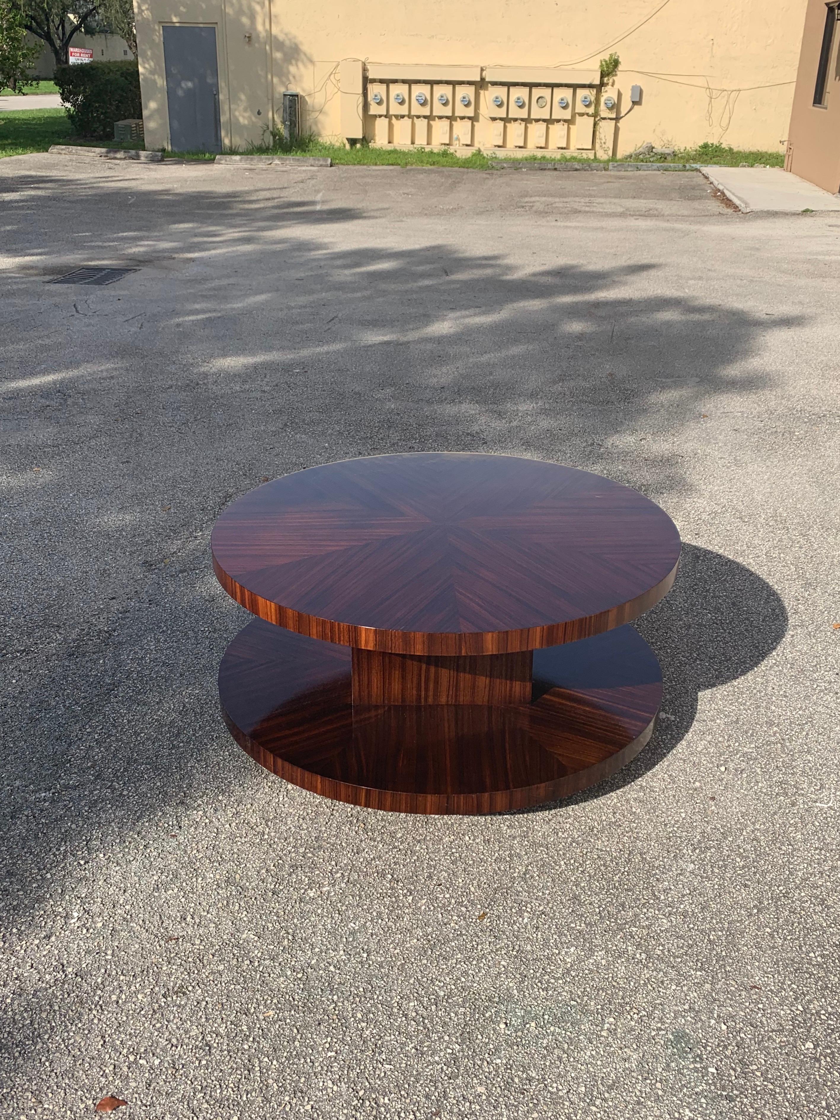 Monumental French Art Deco Macassar sunburst rotating coffee table 1940s, the round coffee table have one center legs with bottom shelf in same Macassar sunburst as top, the top of the table are rotating, this French Art Deco table are in perfect