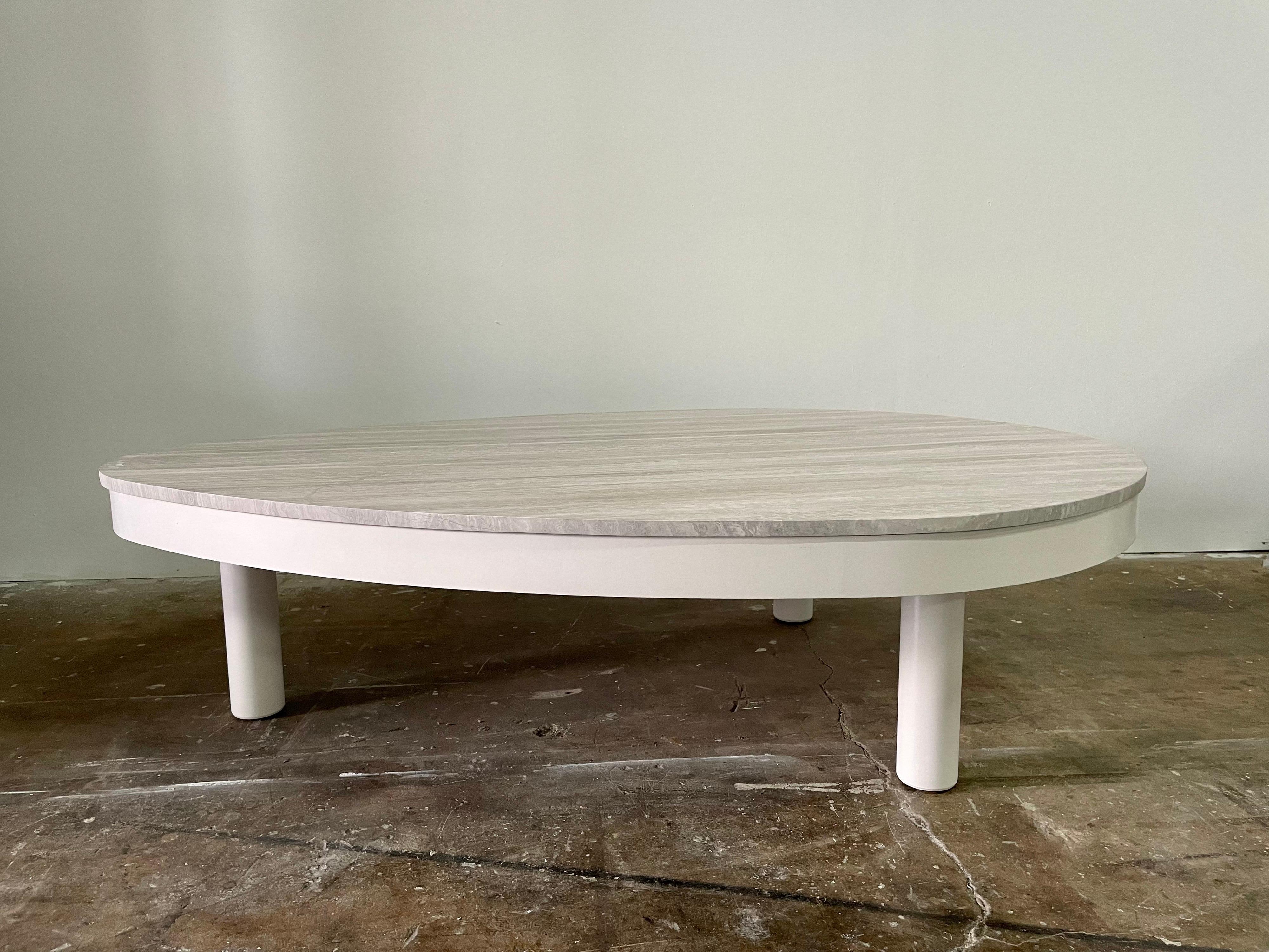 This is a fantastic French Modern biomorphic shaped cocktail table with a 3/4 inch thick slab of beautiful grey marble with a clean and classically chic look. The all wood base has three thick columns for legs and is in great condition. The base is