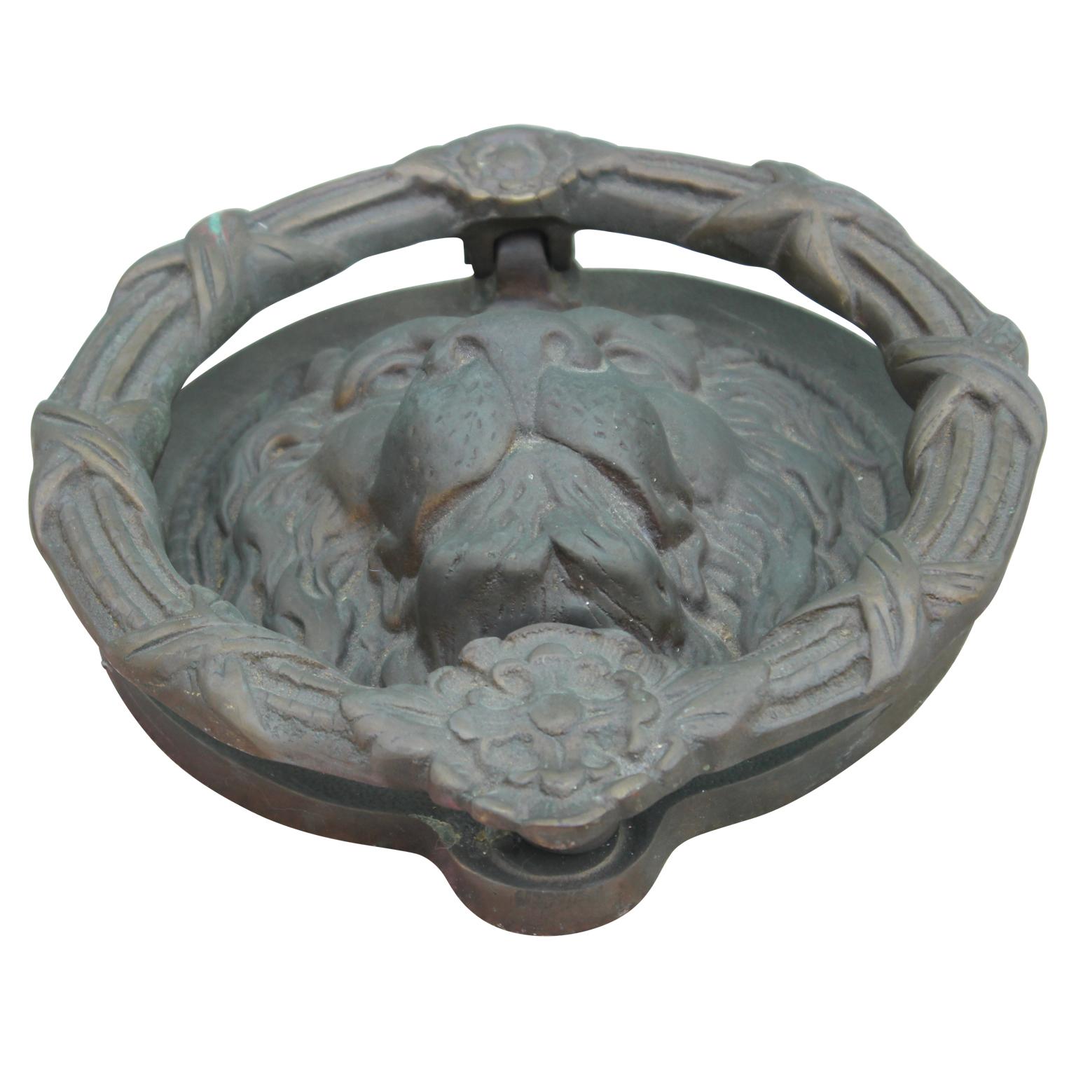 19th century monumental French bronze door knocker in the shape of a lion head in the style of Louis XV. The bronze has a nice patina consistent with age and use.