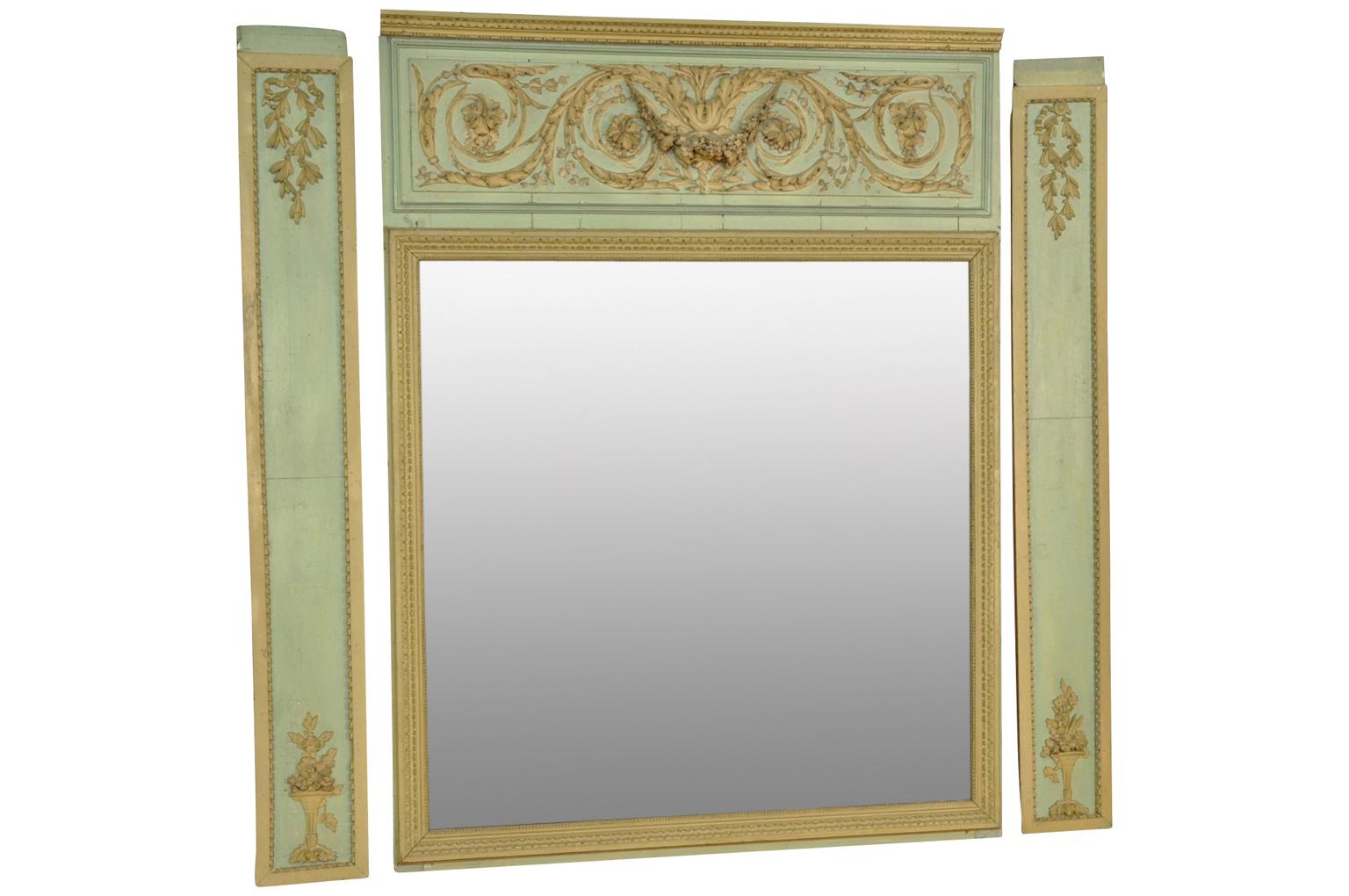 An outstanding and exceptional Louis XVI period trumeau from the South of France. Beautifully constructed from polychromed wood with its original mercury glass mirror. Wonderful carvings decorate the mirror as well as the side panels. Please note