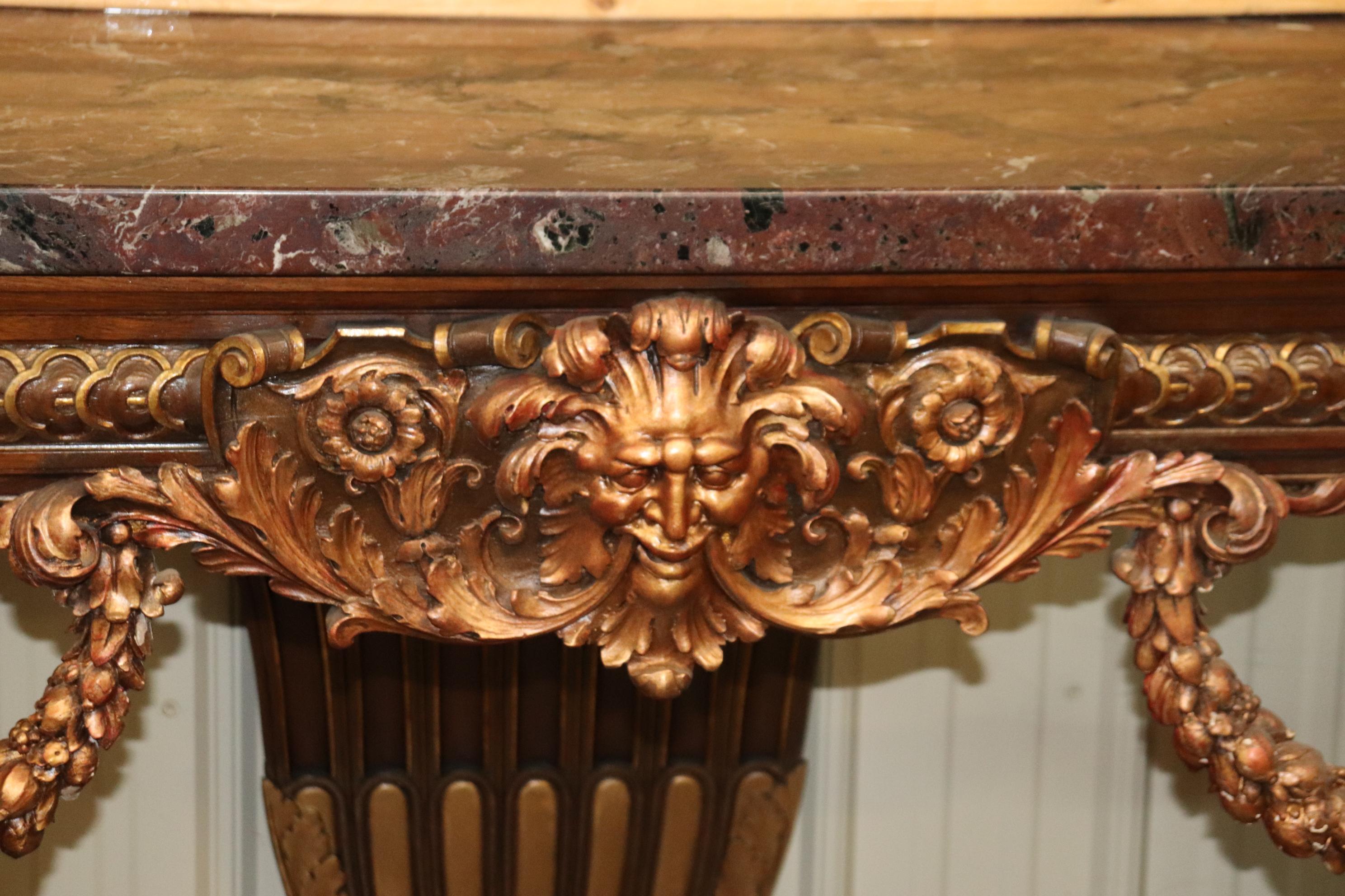 This is a magnificent one-of-a-kind console table for a one-of-a-kind home. The table is absolutely decadent in terms of design and use of elaborate carved details and gilded details. The table dates to the 1880s era and is French and is in good