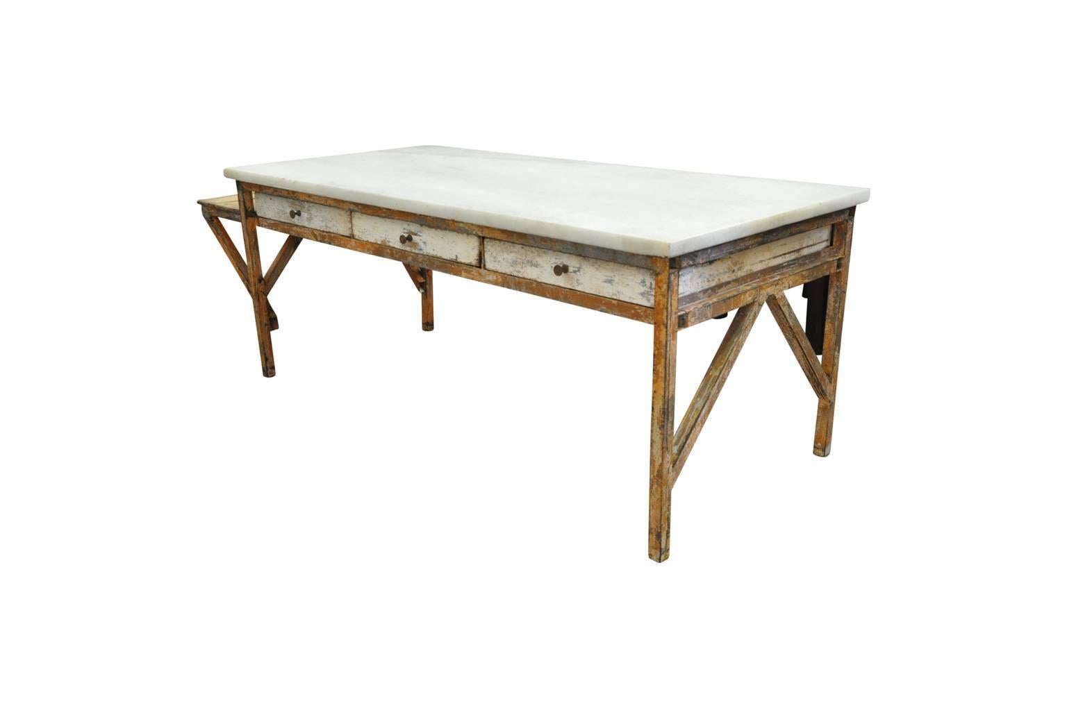 An outstanding and monumental early 20th century French pastry table - table Patisserie - beautifully constructed from marble and iron. A tremendous kitchen island, potting table, bar table or work table.