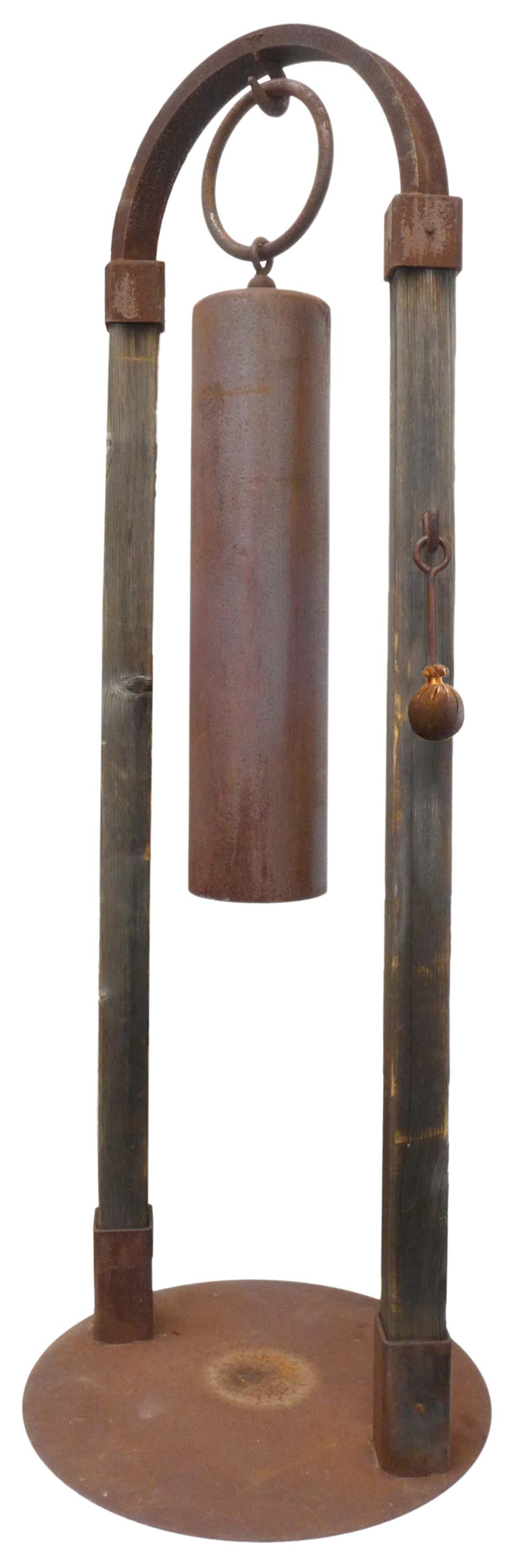 An incredible, monumental garden bell by Tom Torrens. A custom, Japanese-inspired edifice in iron and wood; an arch 7 feet in height suspending a large, cylindrical bell by oversized hook and ring. Custom, original iron and leather striking-mallet
