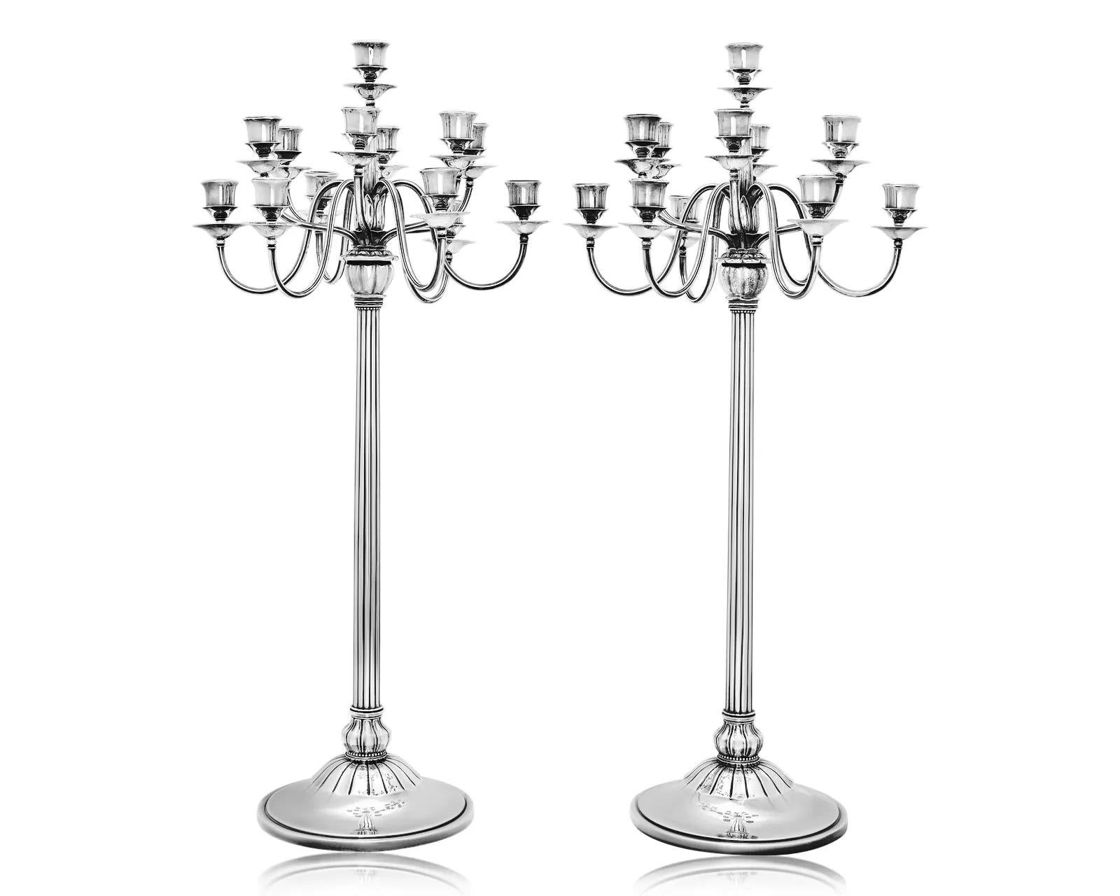 A pair of extraordinary and presumably unique monumental Georg Jensen sterling silver candelabra, designed by Harald Nielsen in 1926. These exceptionally tall and elegant pieces feature thirteen lights/sconces each, showcasing a breathtaking blend