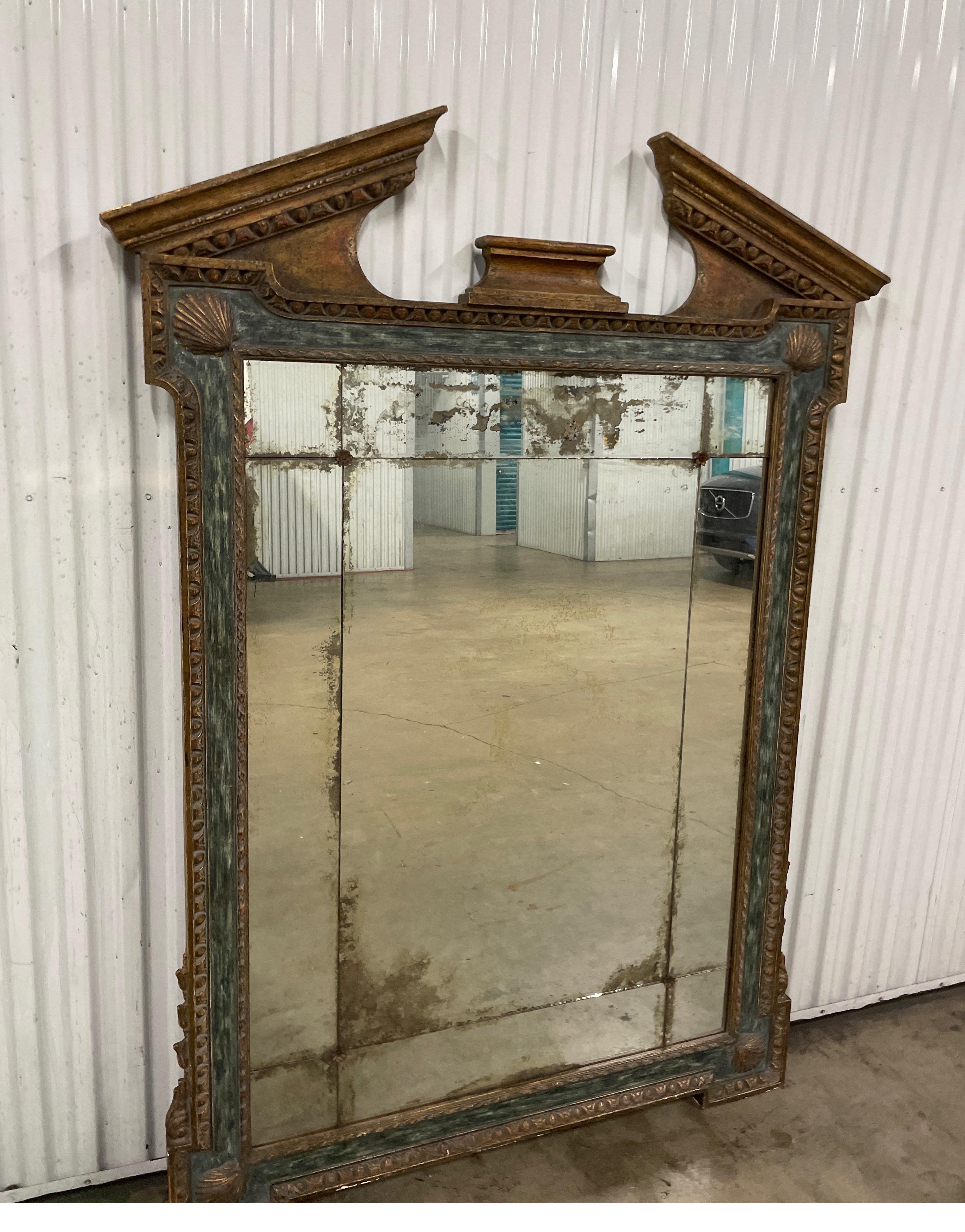 Large scale Georgian style Broken Pediment mirror by Dennis & Leen. This mirror is over four feet wide & just under six feet tall. Beautifully painted & gilded finish gives it an old world patina. Each corner is adorned with a carved seashell.